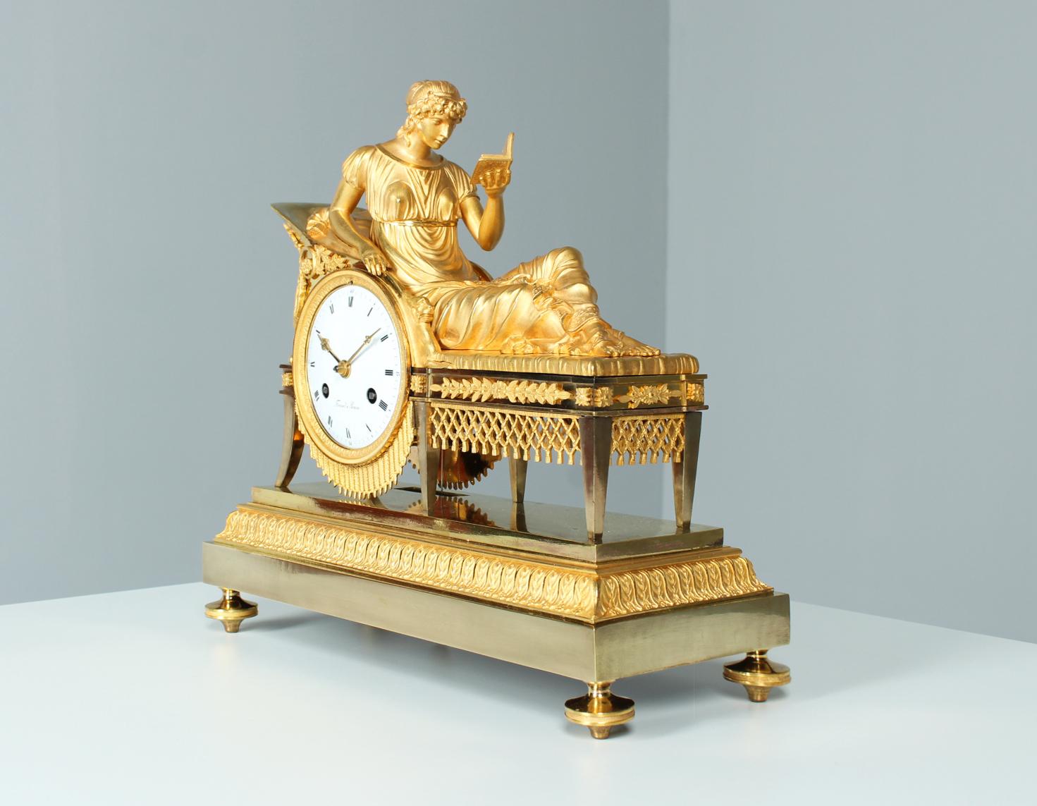 Empire Pendule - La Recamière

France
Bronze, enamel
Empire around 1810

Dimensions: H x W x D: 33 x 35 x 14 cm

Description:
Fancy and rare fire-gilt mantel clock from the Empire period circa 1810.

A young woman is depicted reading on a