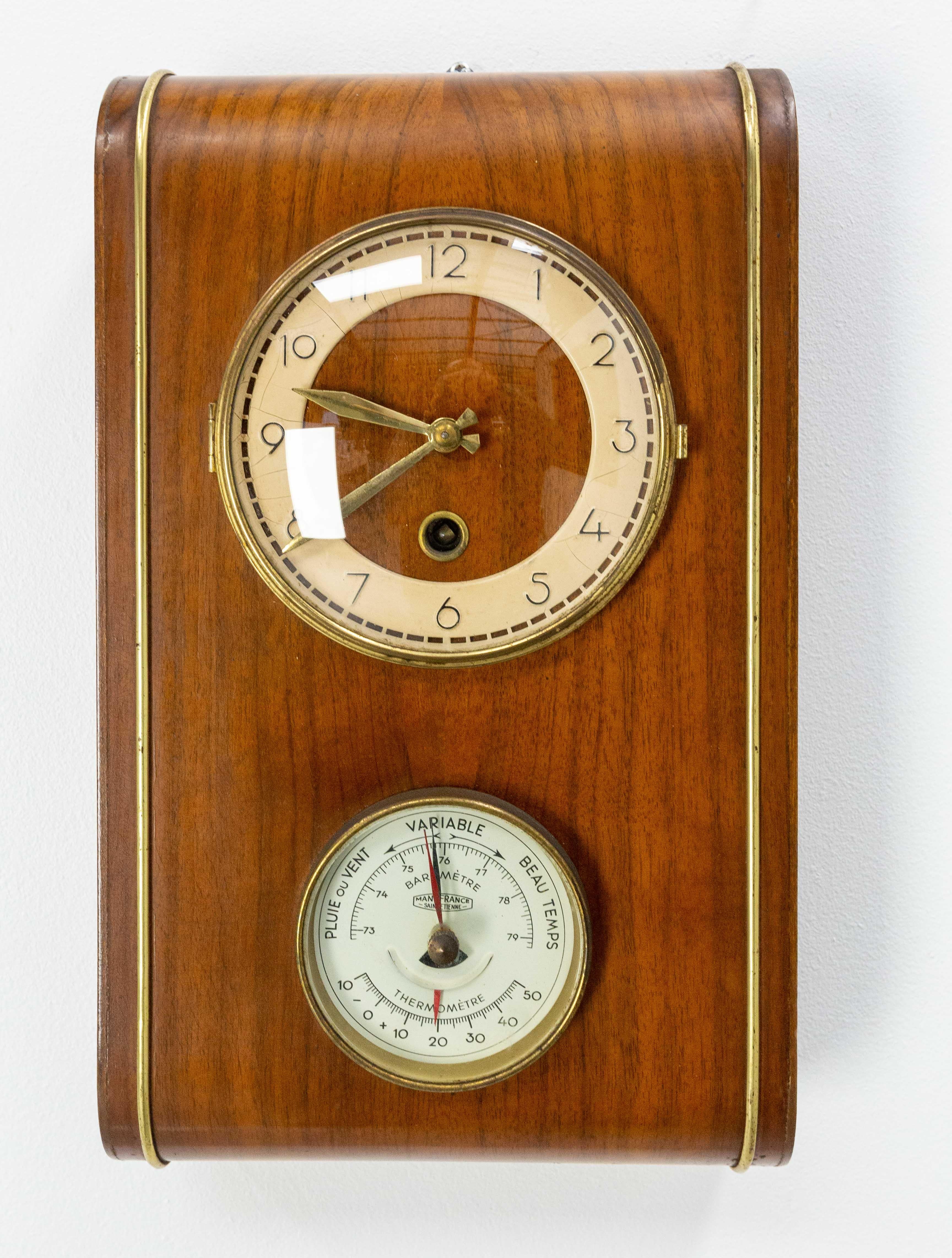Clock and aneroid barometer in walnut made circa 1960.
The aneroid barometer (or holosteric barometer) was developed by the Frenchman Lucien Vidie who filed a patent for it in 1844 (in collaboration with Antoine Redier, inventor of the alarm