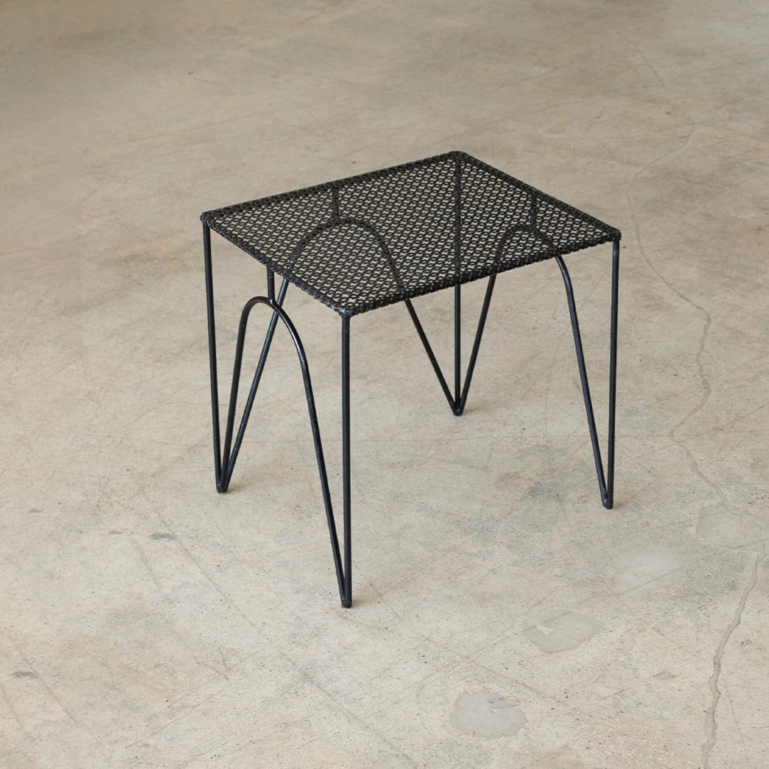 Great rectangular iron side table in the style of Mathieu Matégot from France, 1950's. Perforated metal top and four angled iron legs with original black paint. Perfect between two chairs.