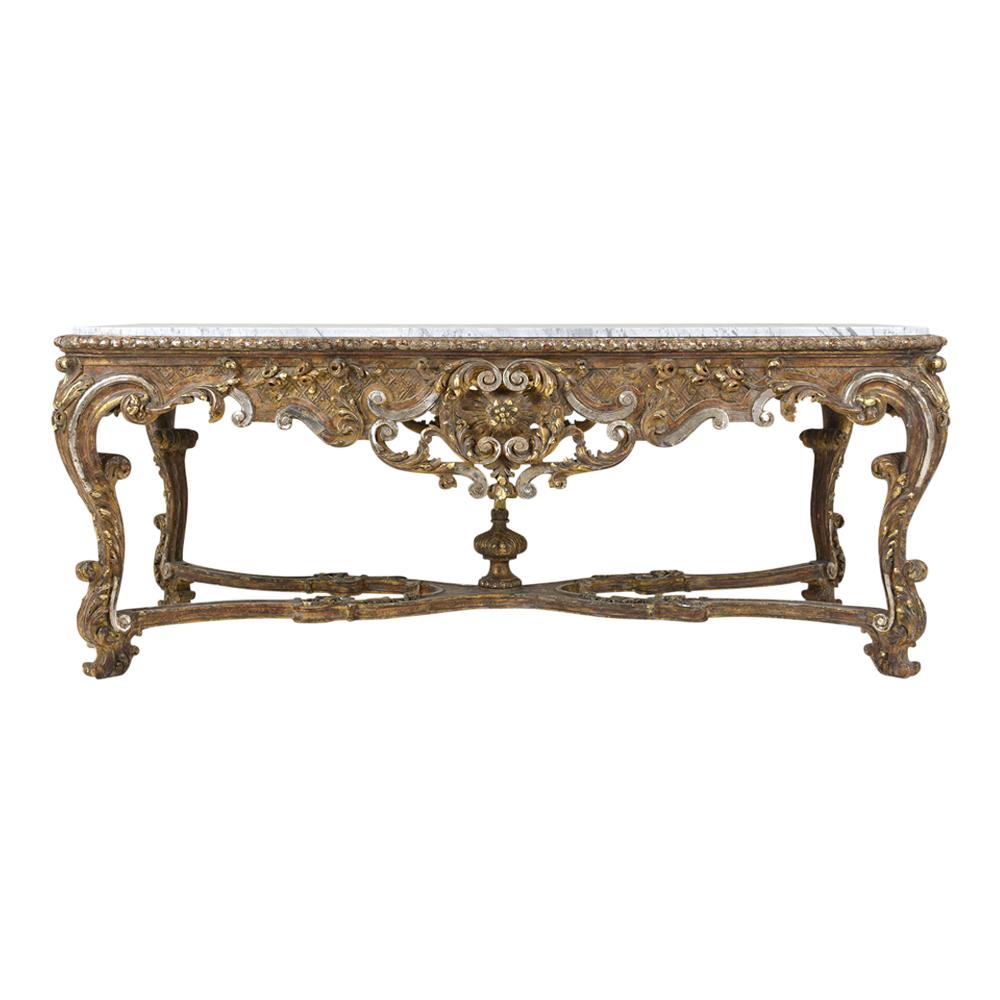 This stunning French Louis XVI Center Table dates back to the early 1800s, is made out of solid wood with intricate hand-carved details, and is in good condition. The console features a white Carrara marble insert with grey veins,  hand-carved