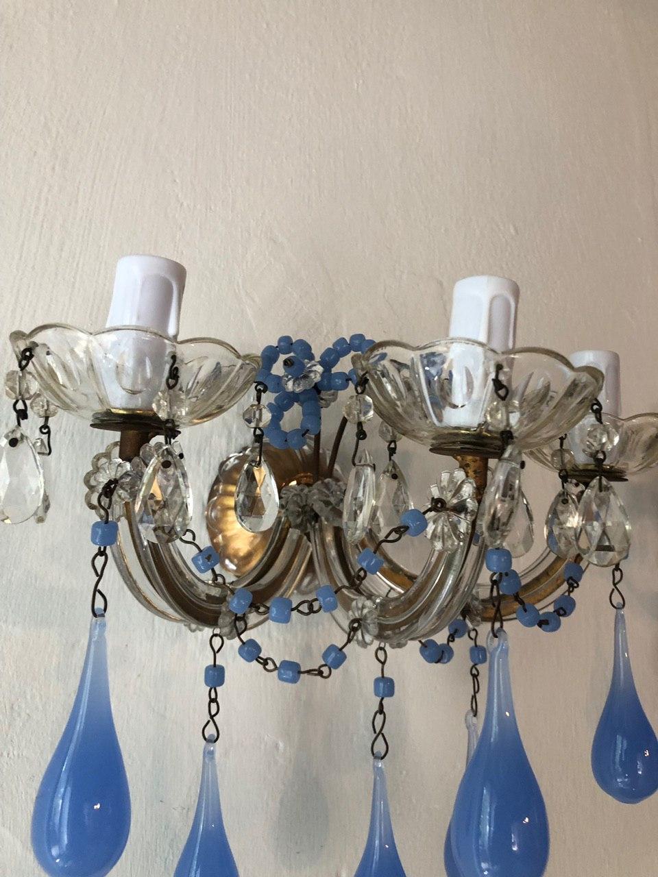 Re-wired and ready to hang! Housing three lights each, sitting in crystal bobeches dripping with crystal prisms. Adorning rare big periwinkle opaline drops as well. Some pictures with the flash make the color look blue, these are true periwinkle