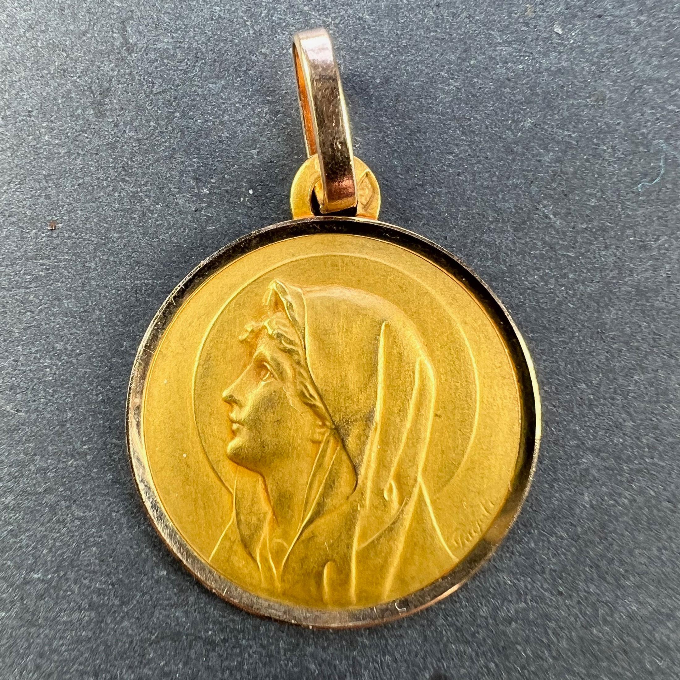 A French 18 karat (18K) yellow gold pendant designed as a round medal depicting the Virgin Mary within a halo. Signed Pageti. Stamped with the eagle’s head for French manufacture and 18 karat gold, with maker’s mark for Perriat.

Dimensions: 2.3 x 2