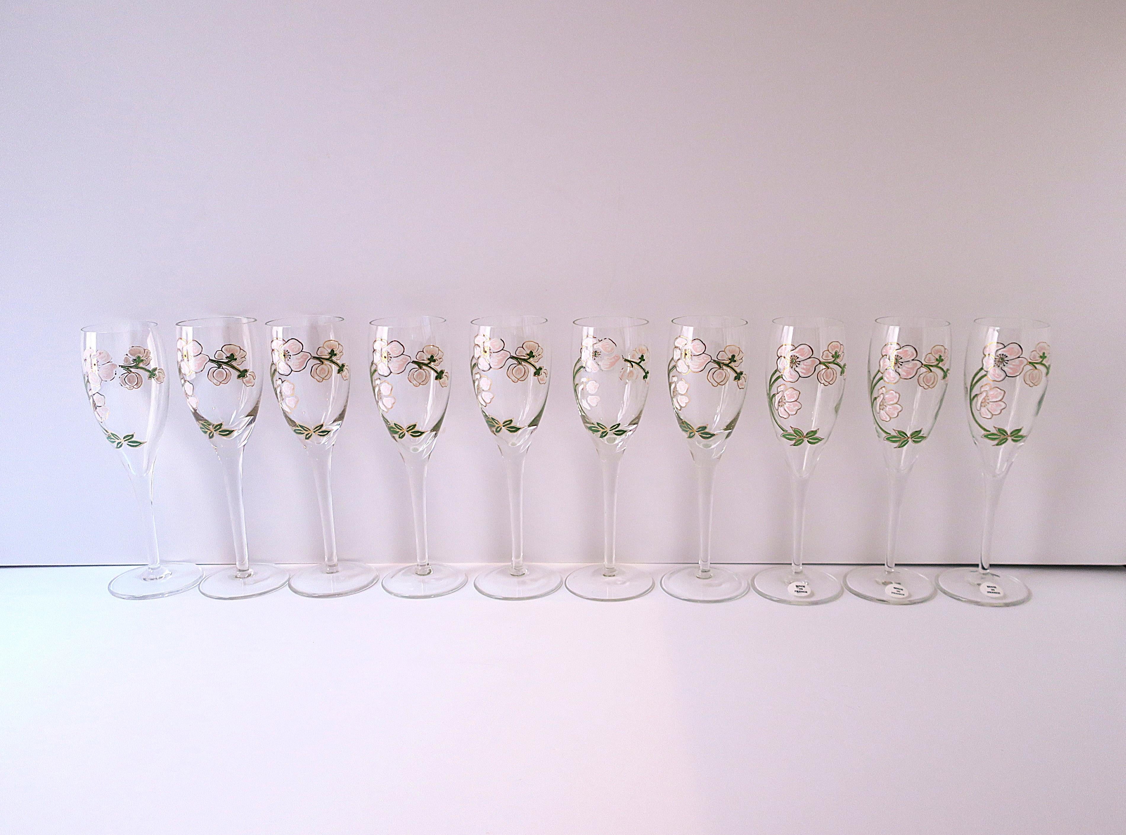 A beautiful set of ten (10) vintage Perrier-Jouet French champagne flute glasses with iconic floral motif in the Art Nouveau style, circa mid to late-20th century, France. This iconic floral design of Japanese pink anemone flowers is from French