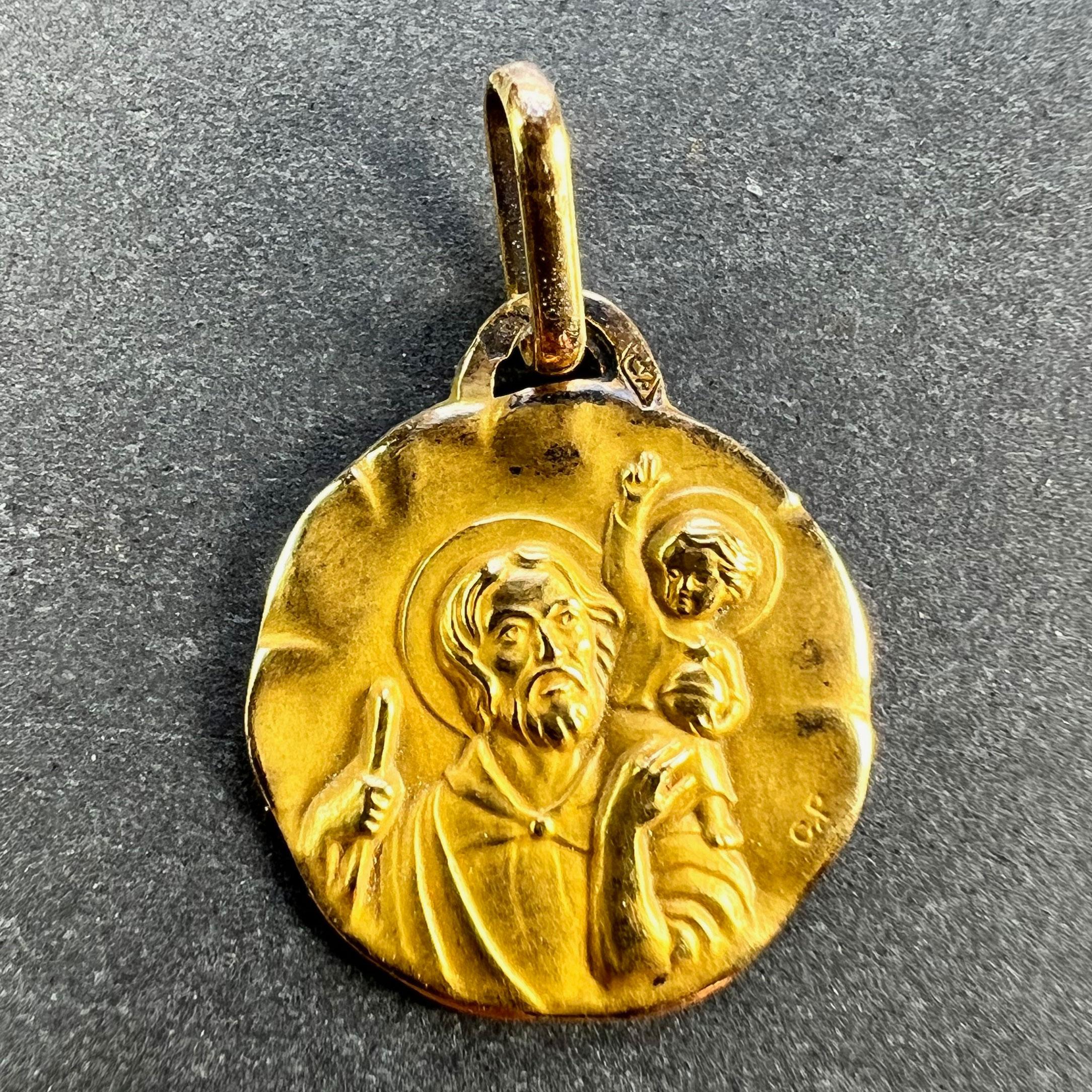 A French 18 karat (18K) yellow gold charm pendant or medal by Perroud depicting St Christopher carrying the infant Christ across the river Stamped with the eagle's head for French manufacture, Perroud's makers mark, and signed CP for