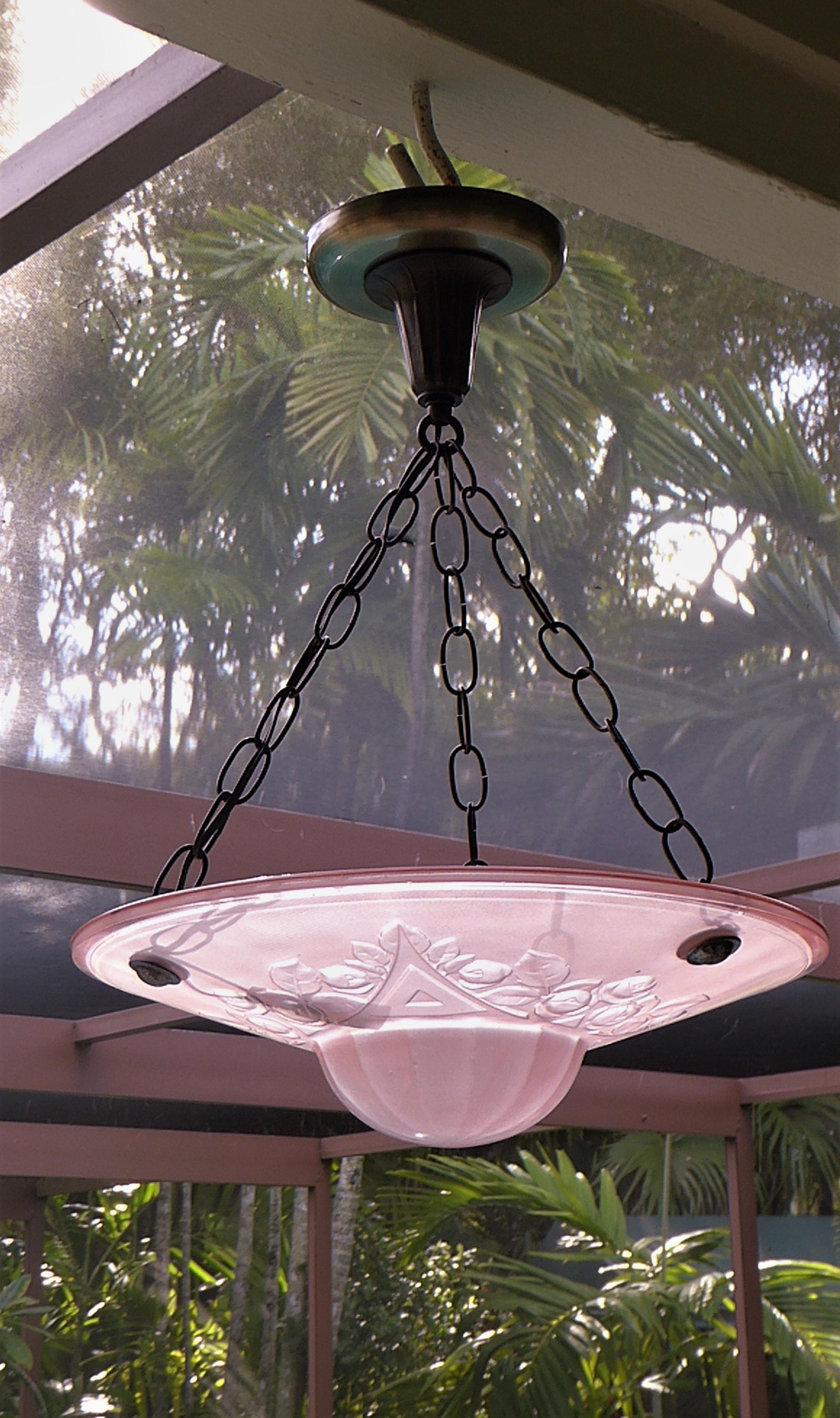 French Art Deco Petit frosted pink glass bowl pendant suspended by three chains from the ceiling canopy. The molded glass bowl with a rose motif in relief and stylized triangles, a dome bottom. Very French, very feminine and lovely. With a single