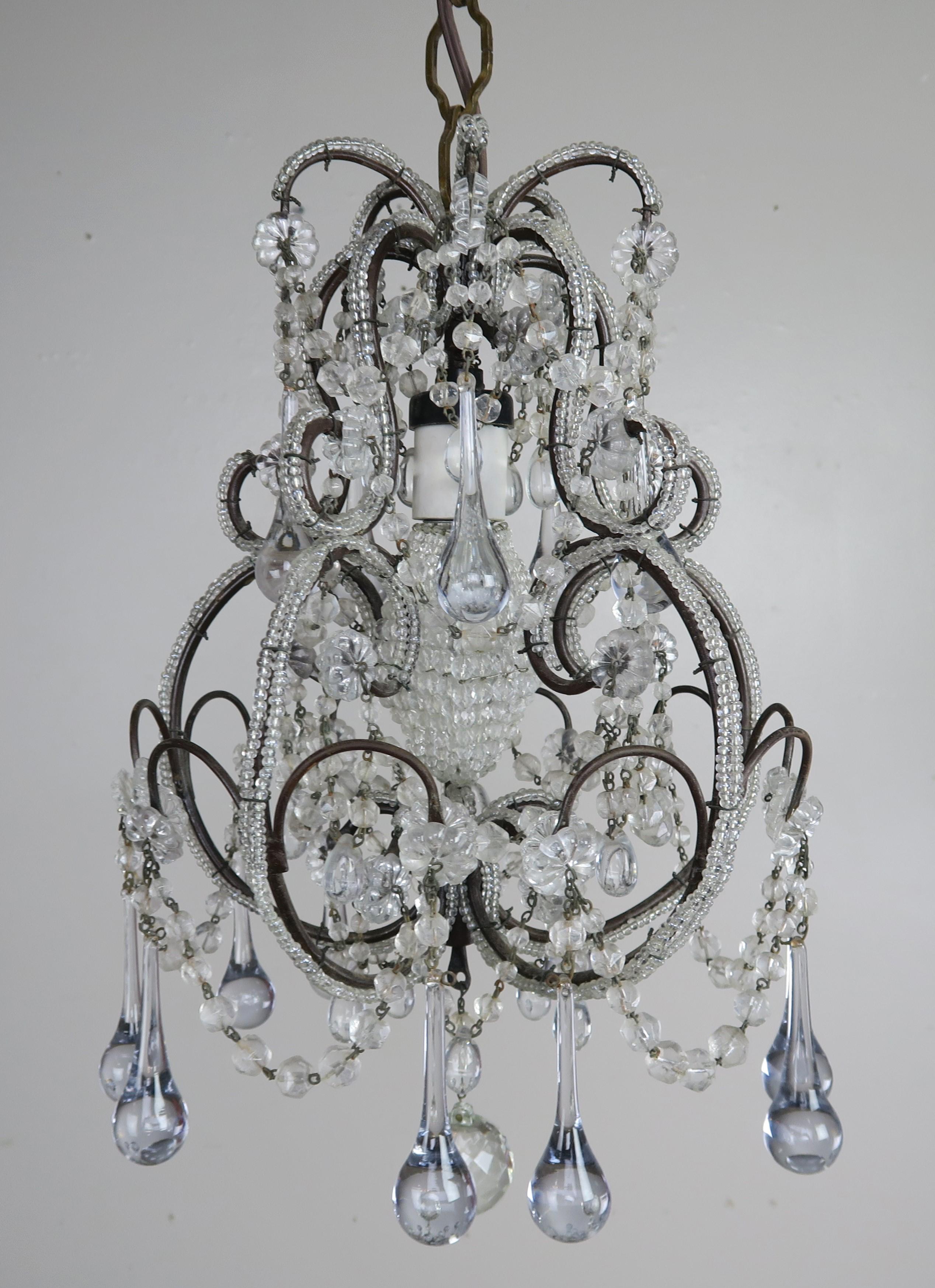 Charming French petite crystal beaded chandelier with clear crystal drops, english cut beaded garlands, and beautiful beaded frame. The fixture is newly rewired and ready to install. It includes both chain & canopy.