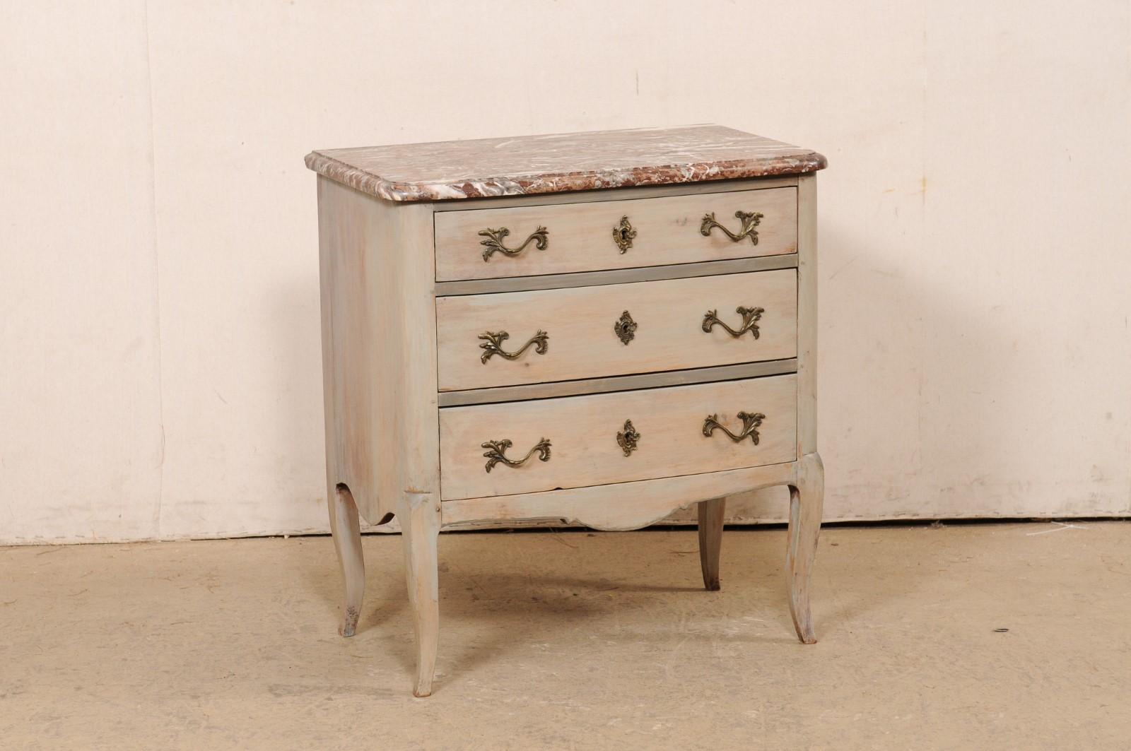 A French small-sized commode with original marble top, from the 19th century. This antique raised chest from France features a beautiful marble top with softly-rounded edges and front corners, which rests atop a case with smoothly-rounded side posts