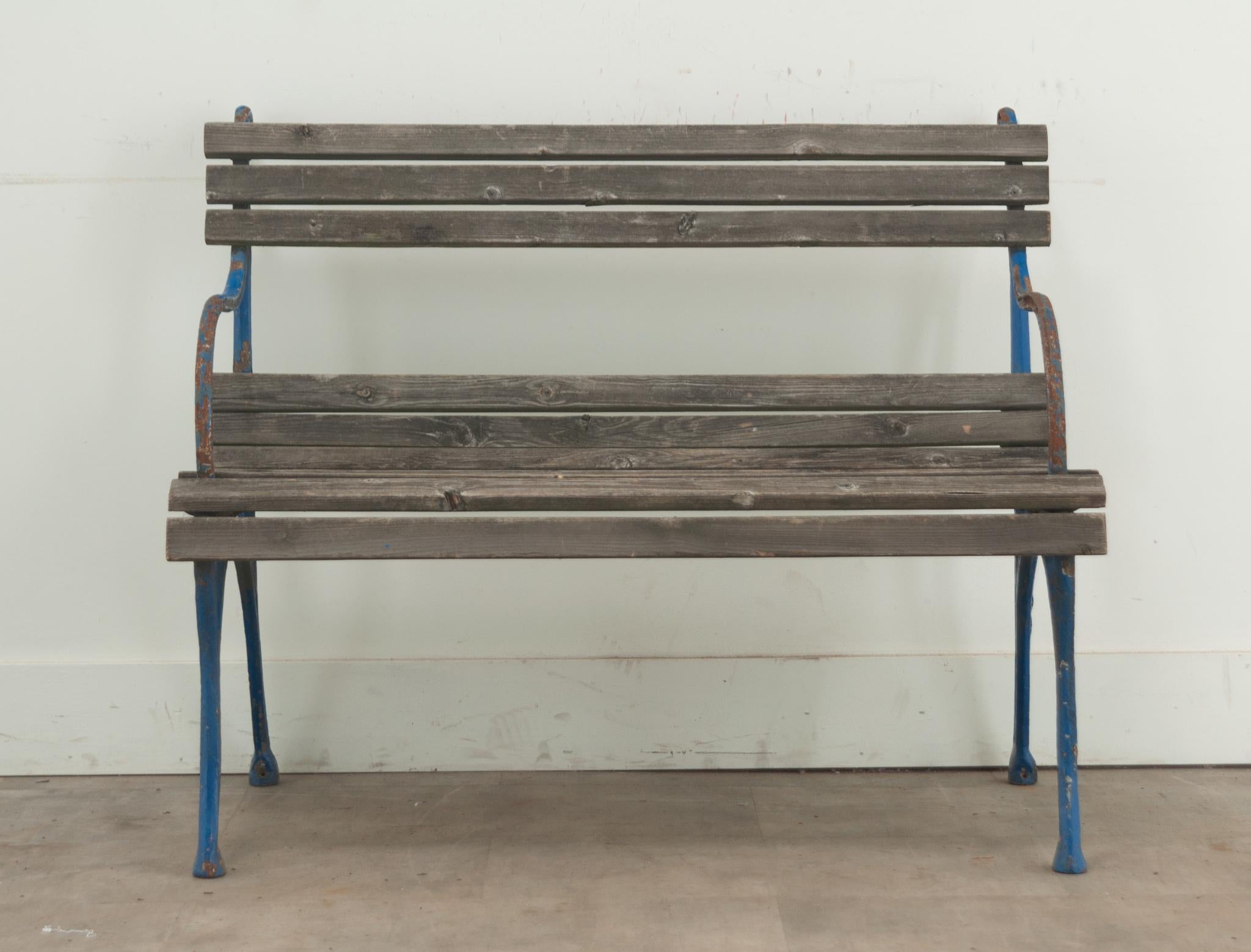 A petite cast iron and wood garden bench from France with a brilliant blue painted finish. Be sure to view the detailed images to see the current condition of this garden seat.