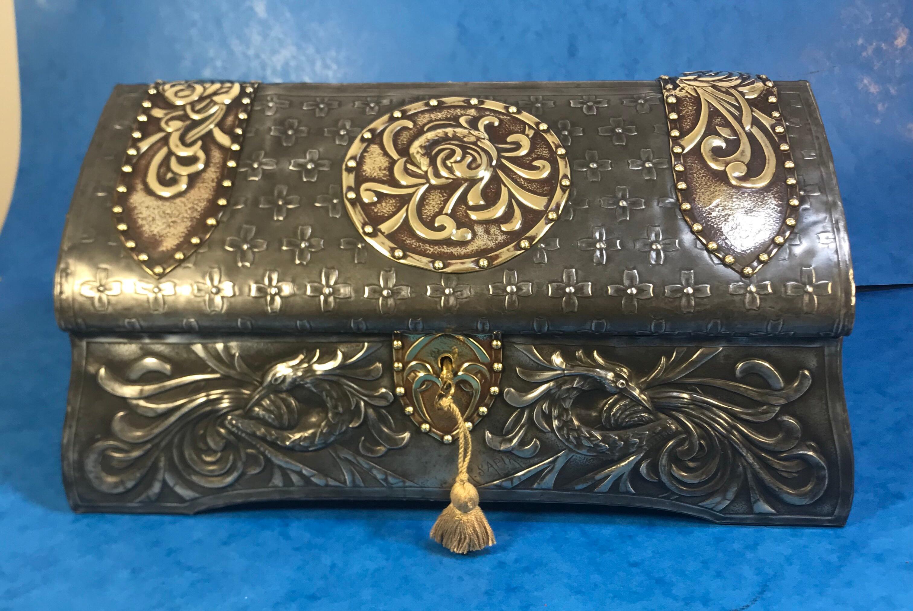 French Pewter Arts & Crafts box.
A very unusual and exquisite Medieval style Pewter and Brass box in superb condition, dating back to 1910. The box has a tented top with pattens and birds heads all around it. It comes with a working lock and key