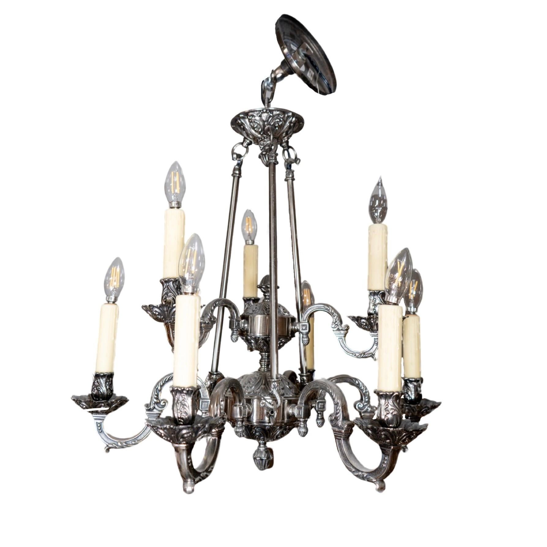 Enhance your living space with a French Pewter Chandelier, crafted from high-quality pewter and wired for easy installation. This midcentury piece will add a touch of elegance to any room, making it the perfect statement piece for your home.