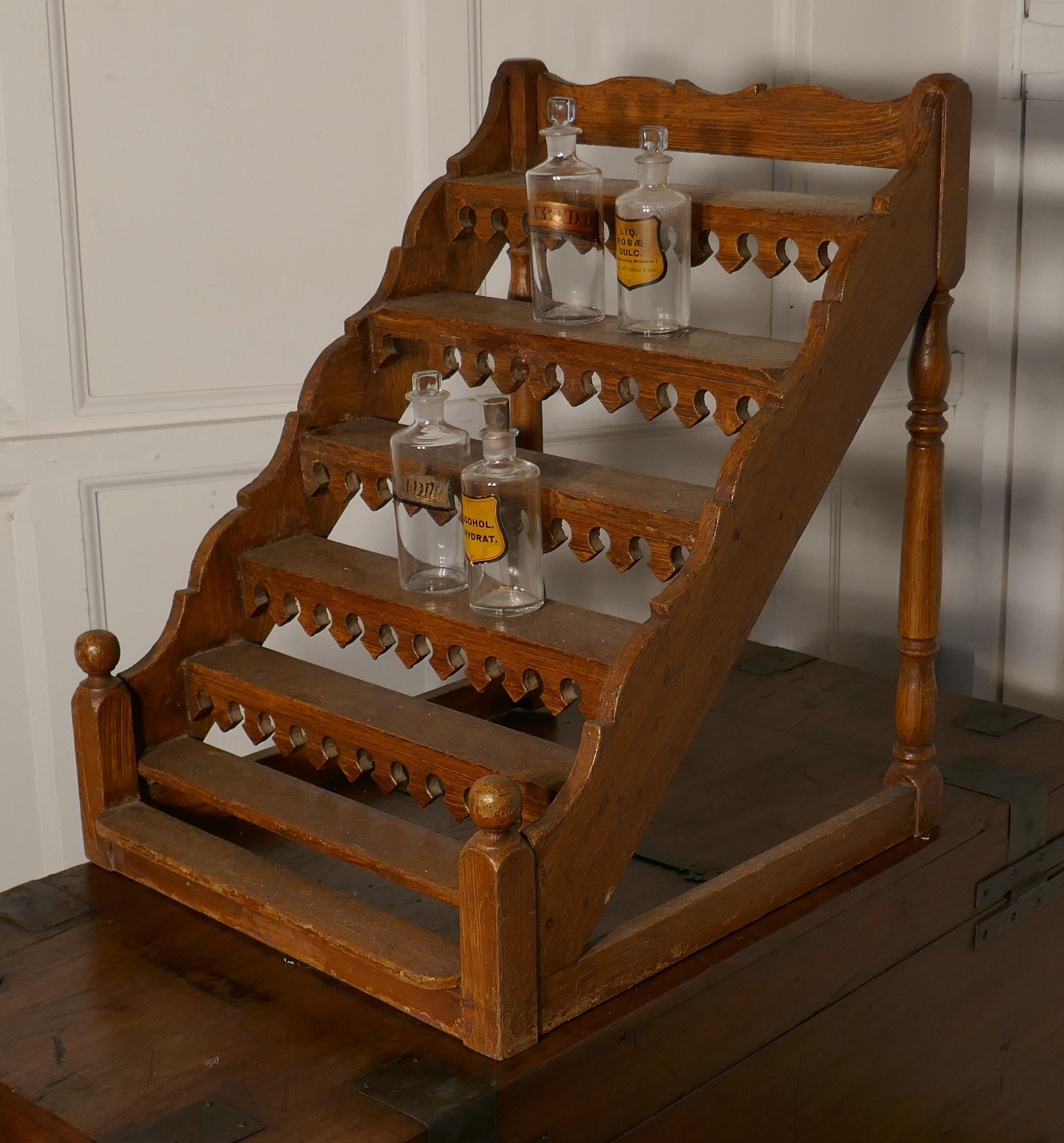 French pharmacy, chemist perfume display stand

This is a delightful shop display rack, it came from a pharmacy in France where it was used on the shop counter to display perfume bottles
The stand looks like a tiny staircase it is made in pine