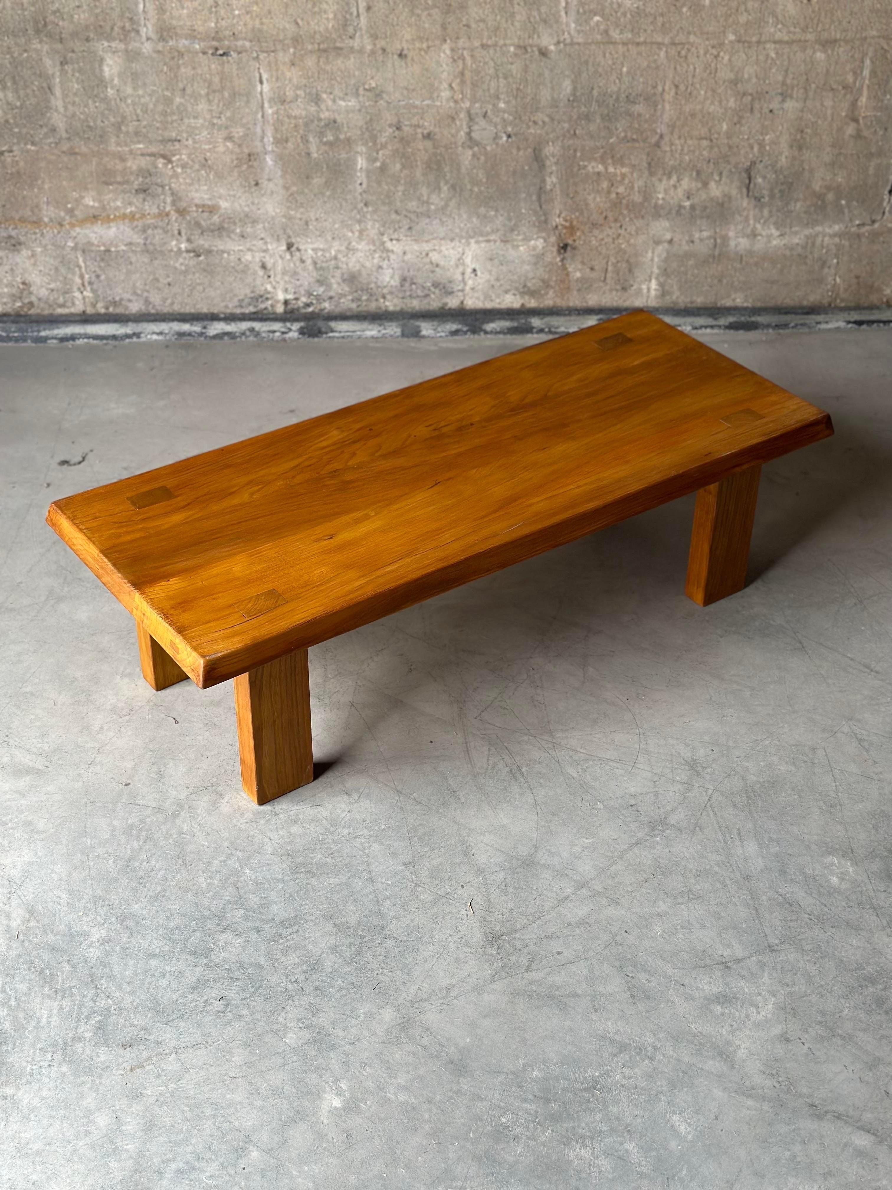 French model T08 A coffee table designed by Pierre Chapo. Starkly designed in elm wood, legs secured with mortise and tenon joints that decorate the top side of the table.