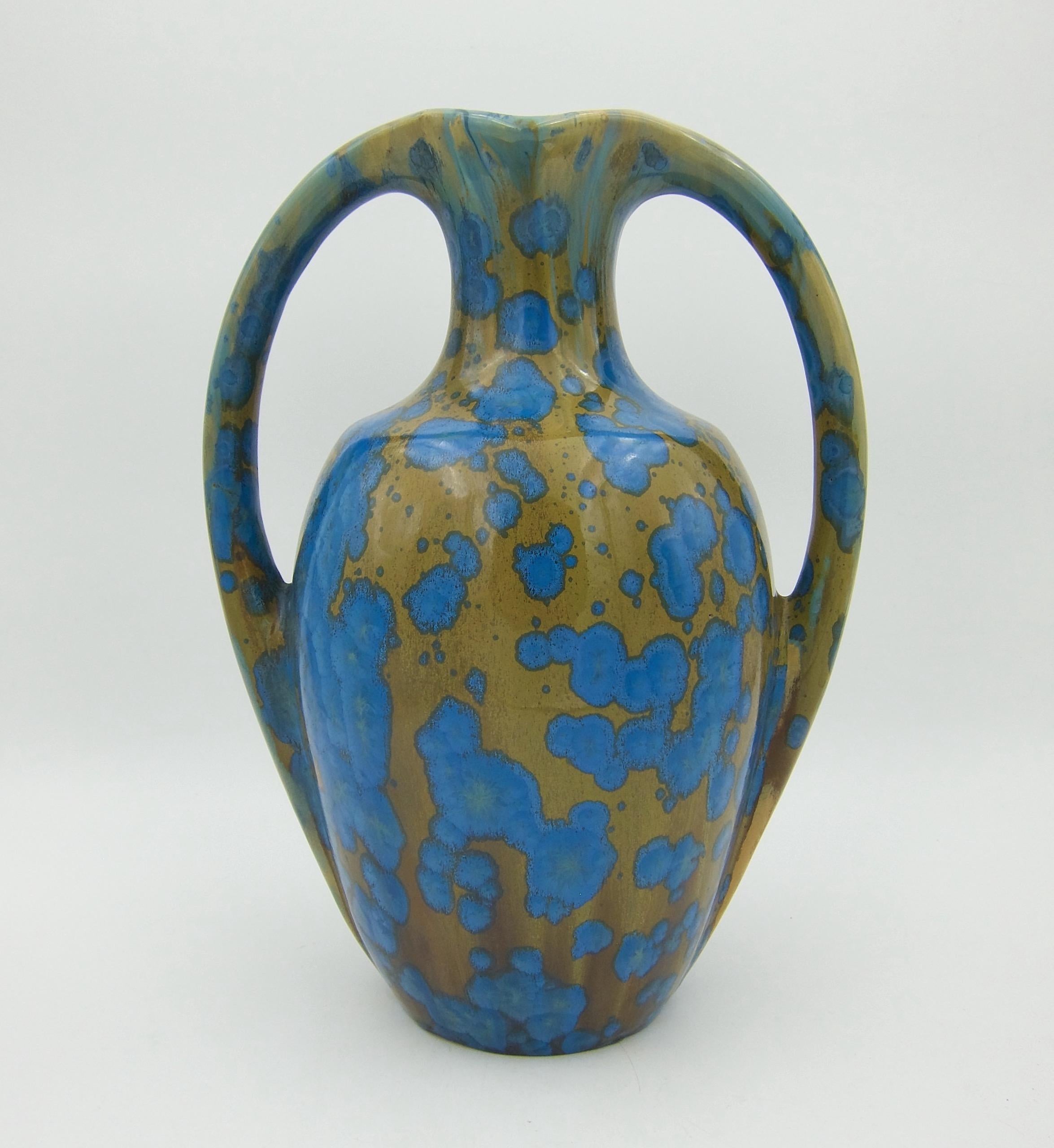 An Art Nouveau two-handle vase from La Faïencerie Héraldique de Pierrefonds Pottery of France. This sculptural and substantial antique vase was handcrafted in stoneware at the turn of the 20th century, circa 1905. Designed with two curved handles