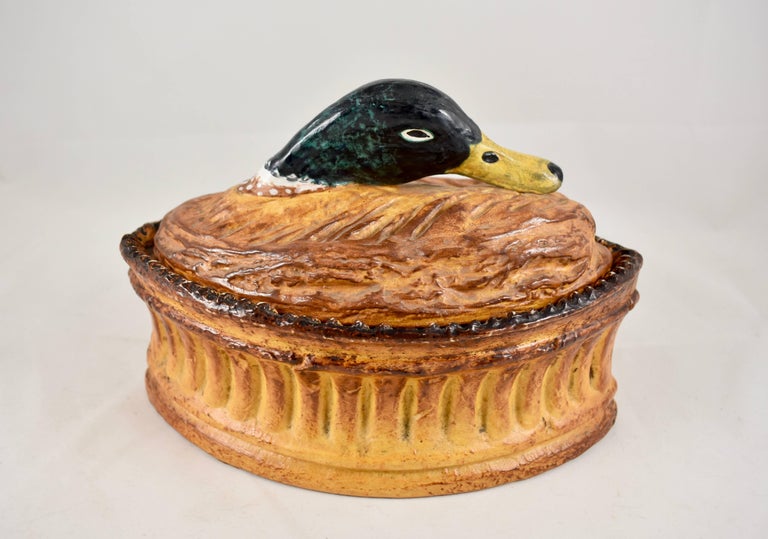 A French trompe l’oeil porcelain pâté terrine, Pillivuyt Mehun, circa 1900. Pillivuyt produced a variety of porcelain terrines inspired by the hunt and for serving game pies or pâté. 

The type of fowl or game poking it’s head out from the golden