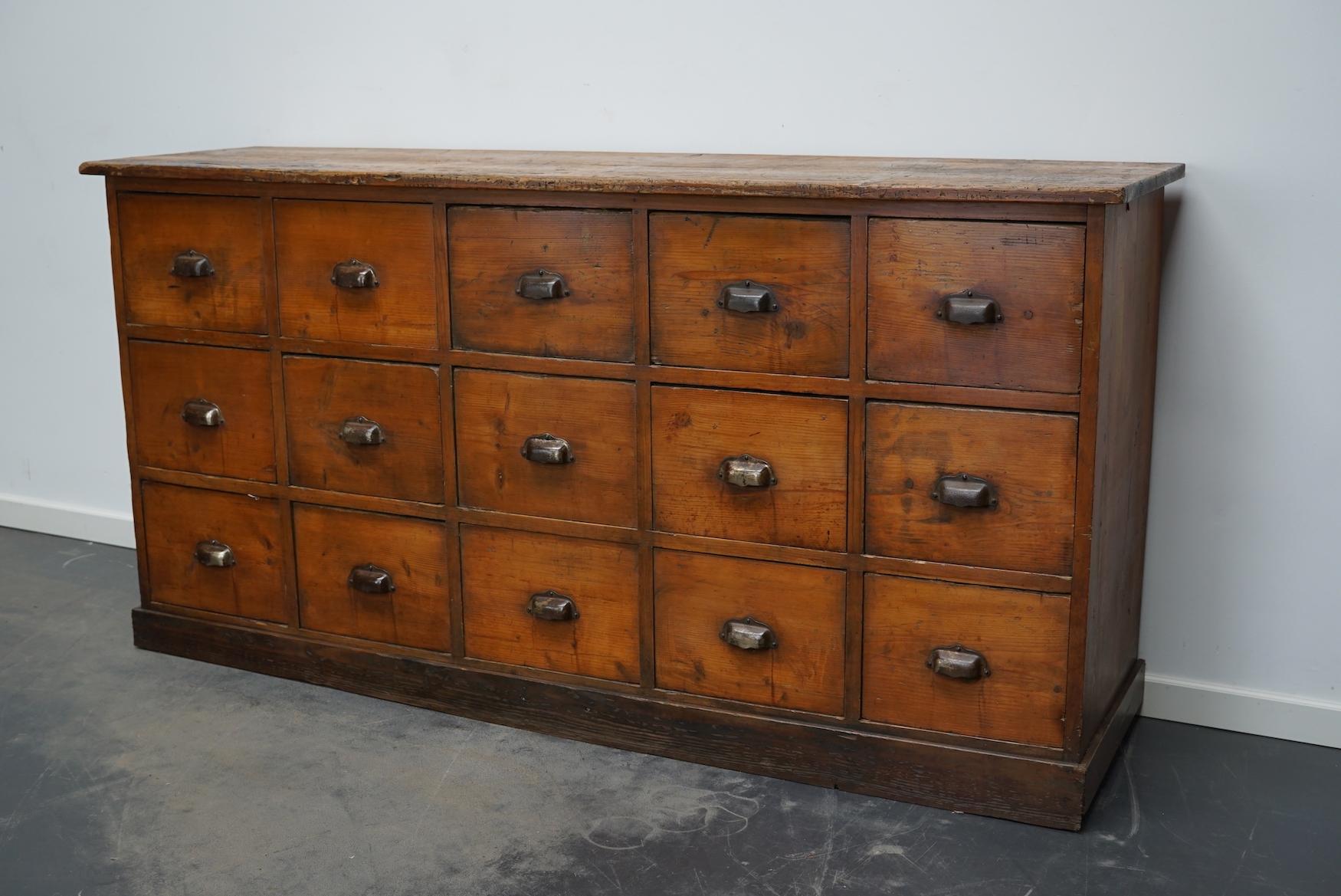 This workshop cabinet was made from pine in France circa mid-20th century. It features 15 decent sized practical drawers with metal cup handles. The interior dimensions of the drawers are: DWH 39 x 28 x 20 cm.
  