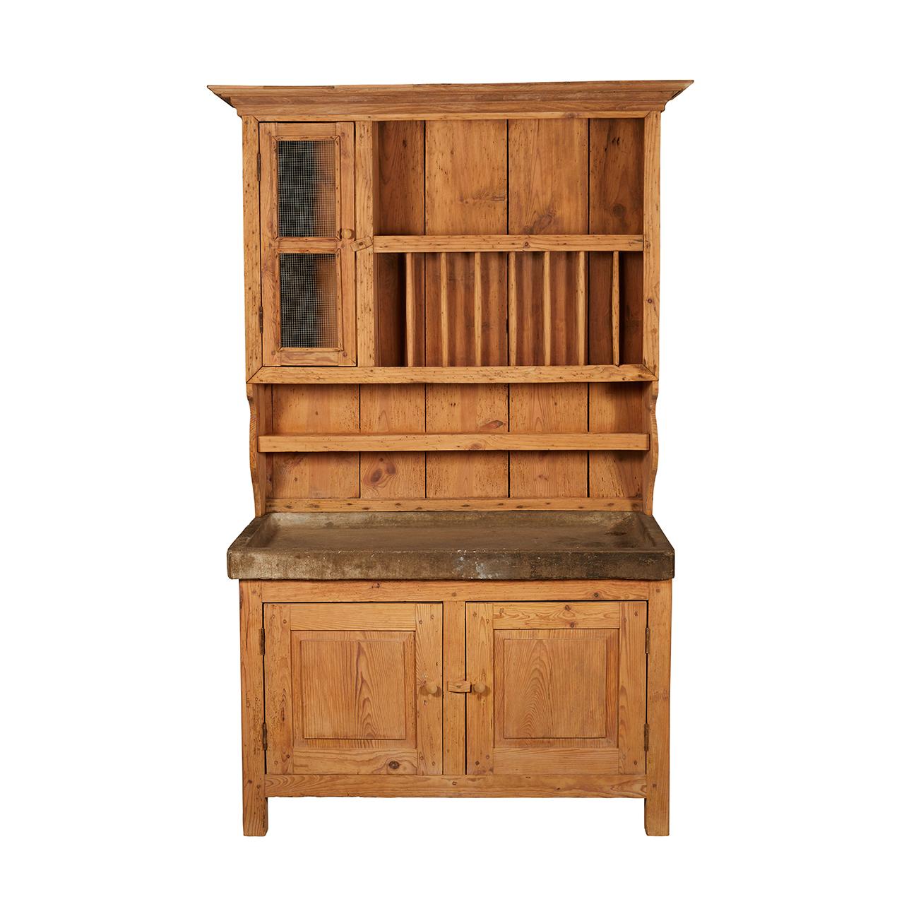 This French pine cabinet has a concrete top which was formerly a sink. Above the sink is a lovely plate rack and shelves with newly replaced wire mesh on the small door. Below are two doors with shelves for storage.
  