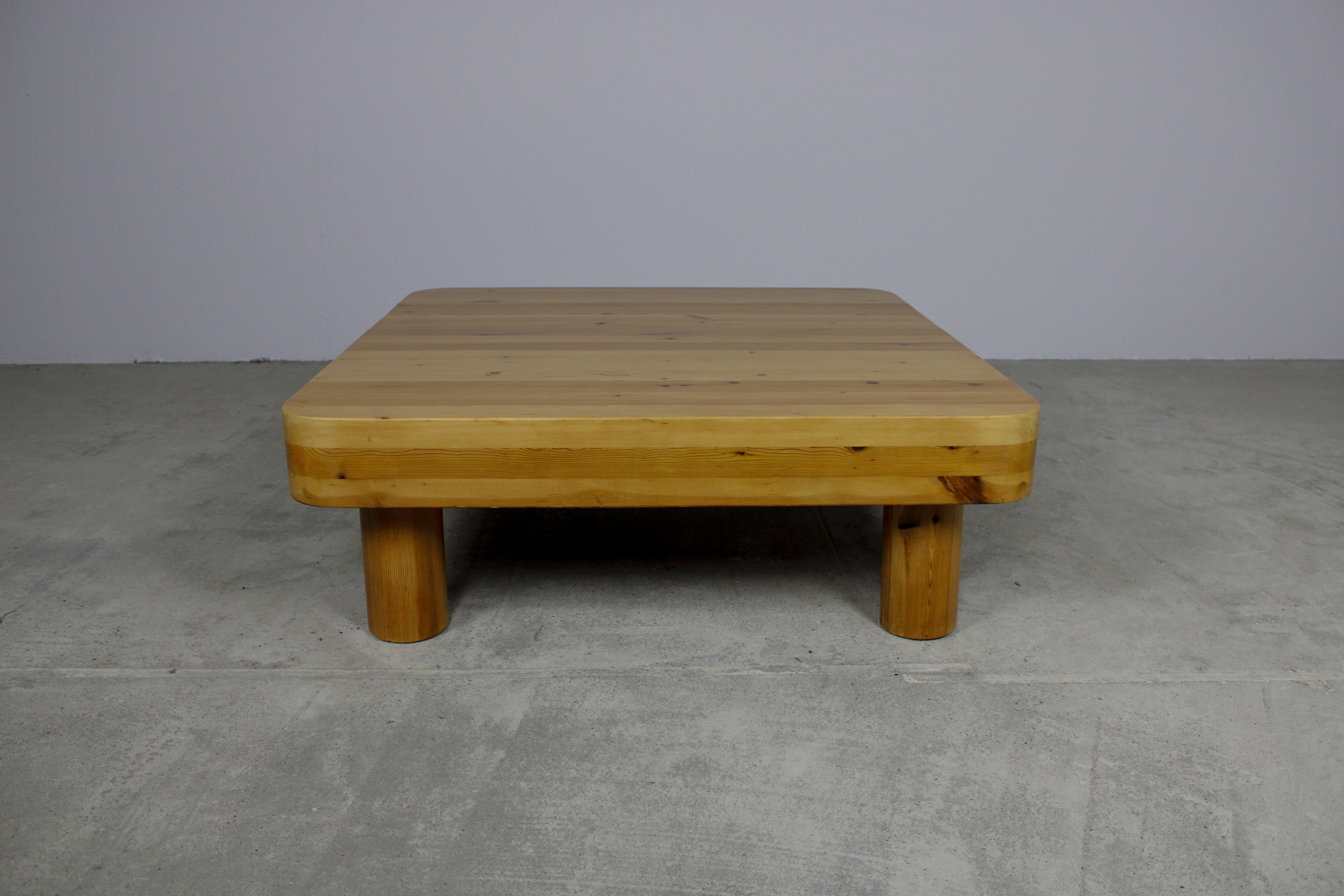 This square pine coffee table embodies rustic charm and understated elegance, drawing attention with its simplicity and natural allure. Crafted from solid pine wood, this table celebrates the inherent beauty of the timber, showcasing its warm tones,