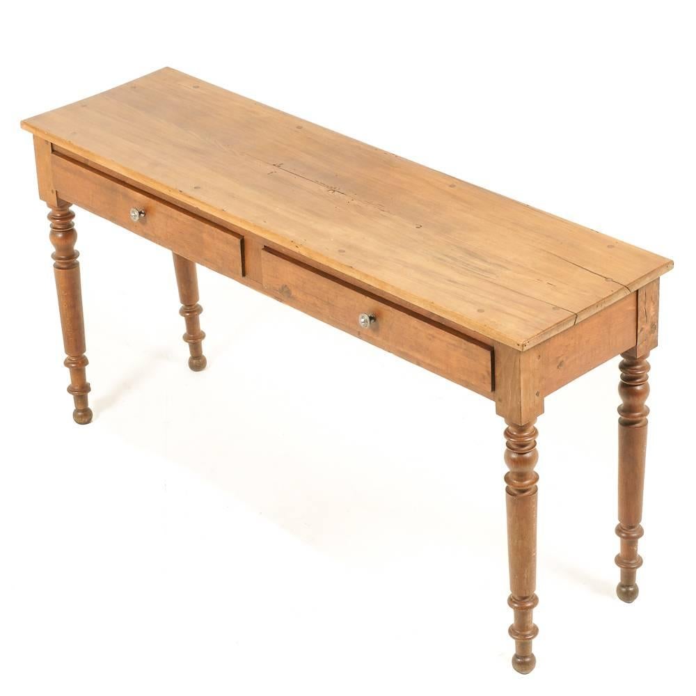 A French pine hall, or console, table with two drawers, supported on turned, tapering legs. A vintage table in the style of an antique piece, circa 1950.



 