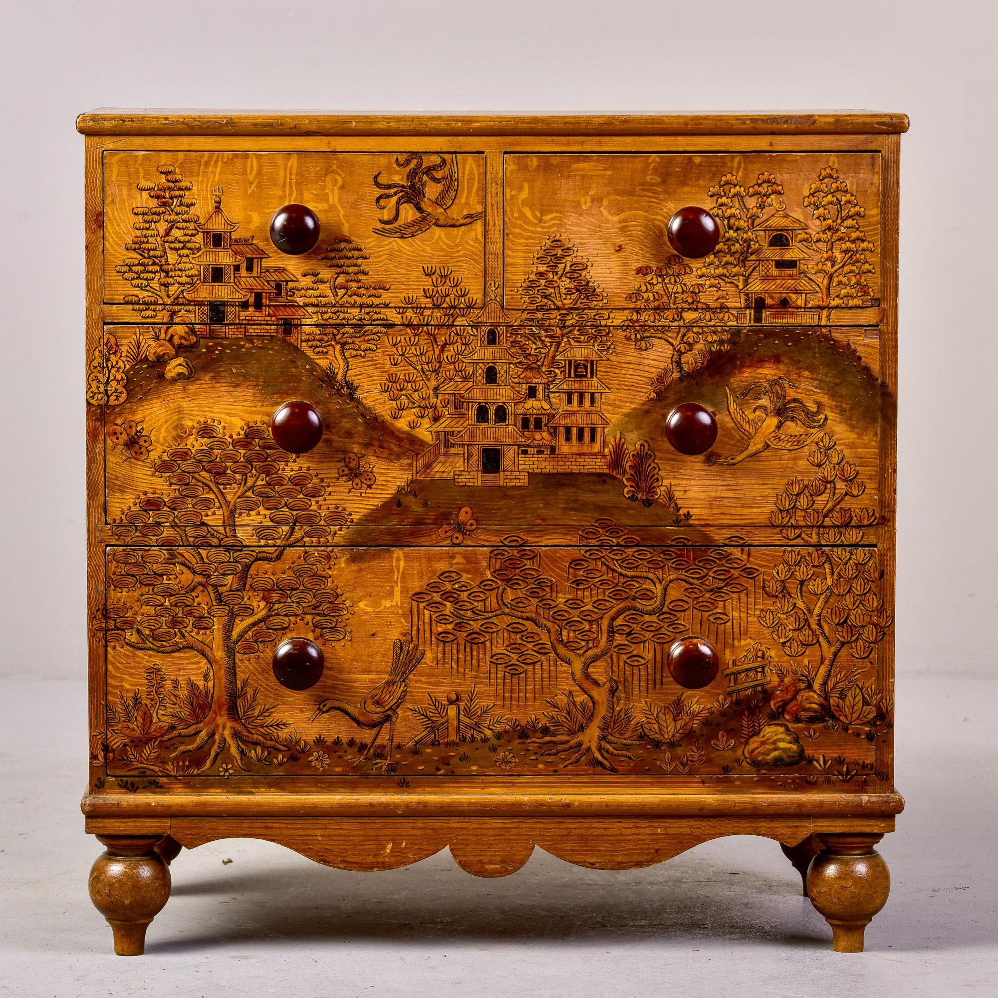 Circa 1940s French pine chest of four drawers with round feet, a curvy apron and elaborately rendered hand painted Asian scene in gold and black. Dovetail construction on drawers, contrasting dark wood knobs. Unknown maker.