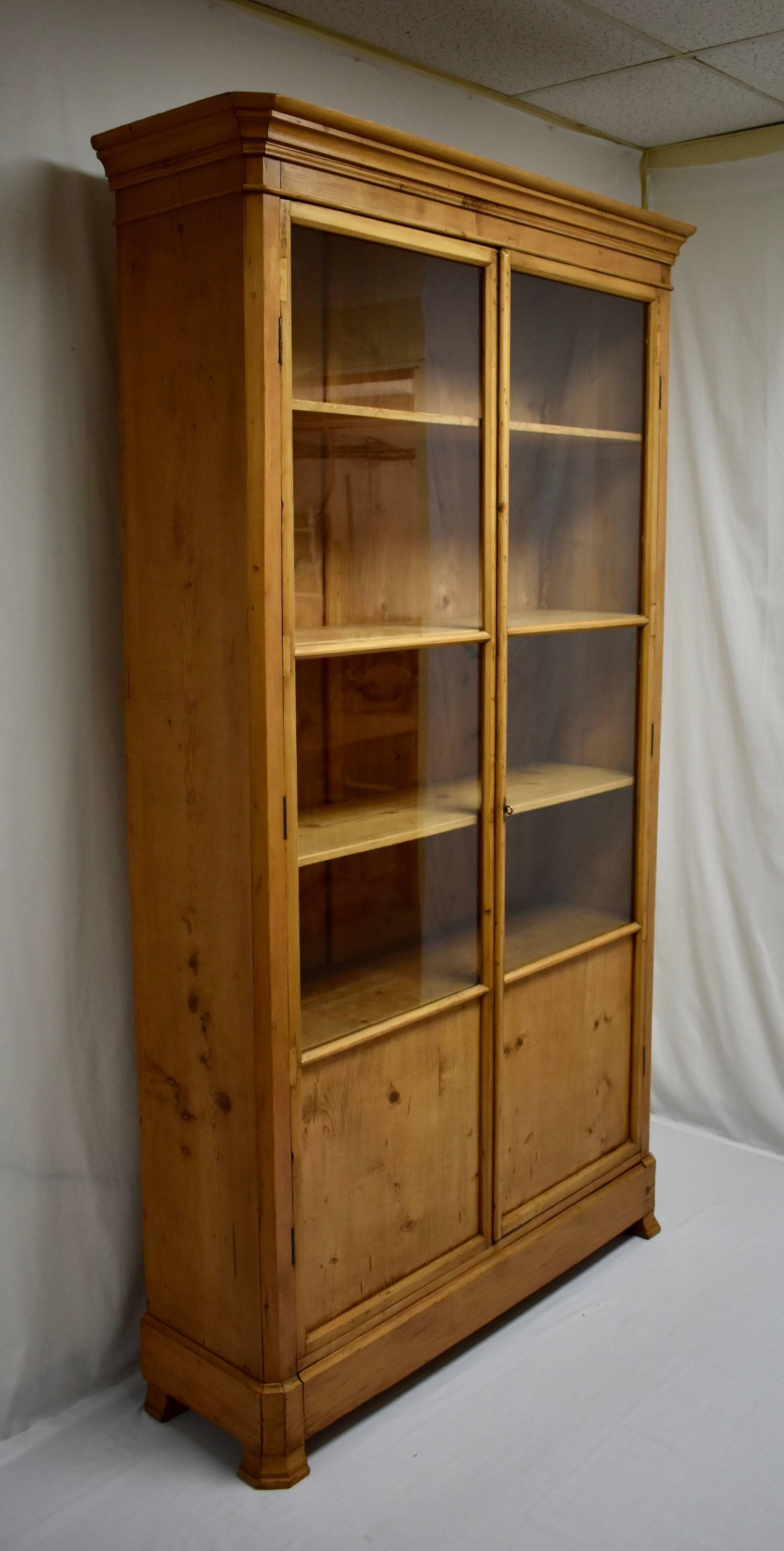 A fine example of the understated elegance of much 19th century French pine furniture, this tall and slender bookcase has been in this dealer's family for the last twenty years, and we rarely acquire such pieces now. Beneath a Classic French ogee