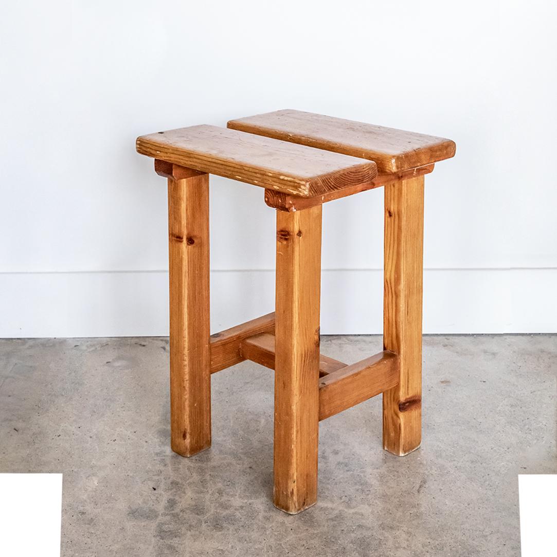 French square stool in the style of Charlotte Perriand's furniture from Les Arc. Pine wood with original finish and great age and wear. Pair available, priced individually. 