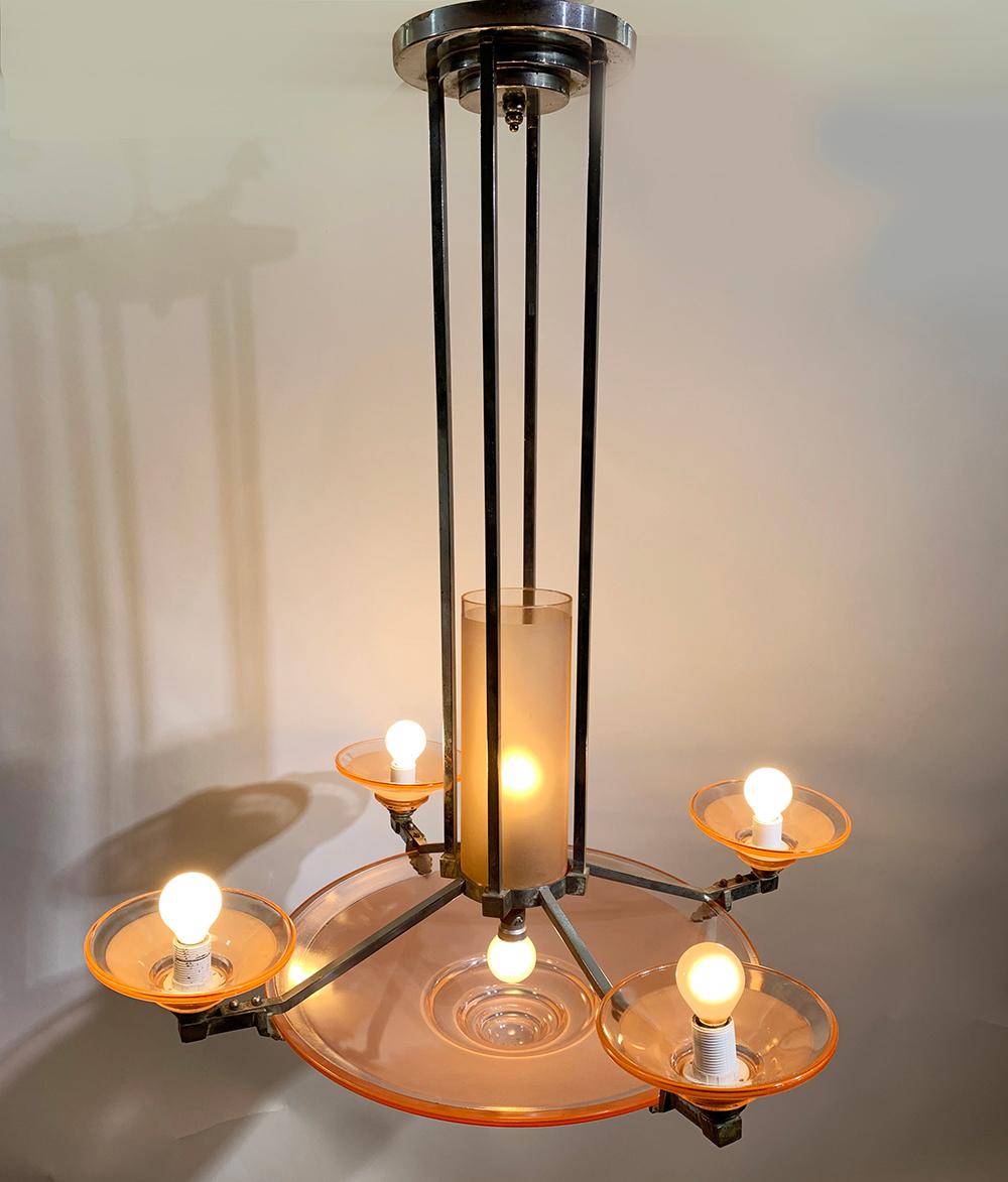 Elegant Art Deco chandelier in chrome/nickel over bronze with pink glass.
This high quality nickel plated bronze metal work by the famous company of H. Petitot, circa 1935, Also refered to as Atelier Petitot, having a central cup with 4 side shades