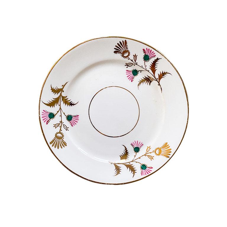 A set of three pink, green, and gold ceramic saucers. This set is beautifully decorated in pink and green flowers, with gold details. Mix and match this set with your other antique china for a colorful look at your next dinner party.