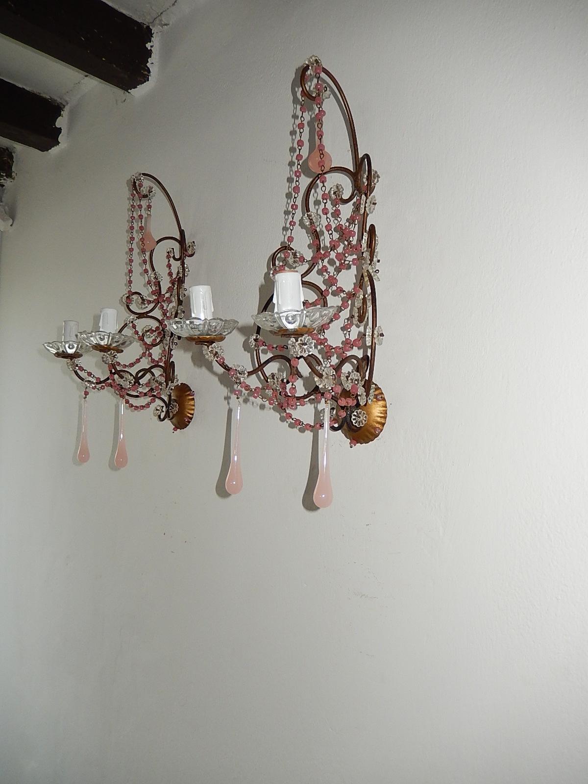 Housing 2-light, sitting in crystal bobeches.  Swags of pink opaline beads and florets throughout. Adorning Murano pink opaline drops. Beads on back plate as well. Will be newly rewired with certified US UL sockets for the Usa and appropriate