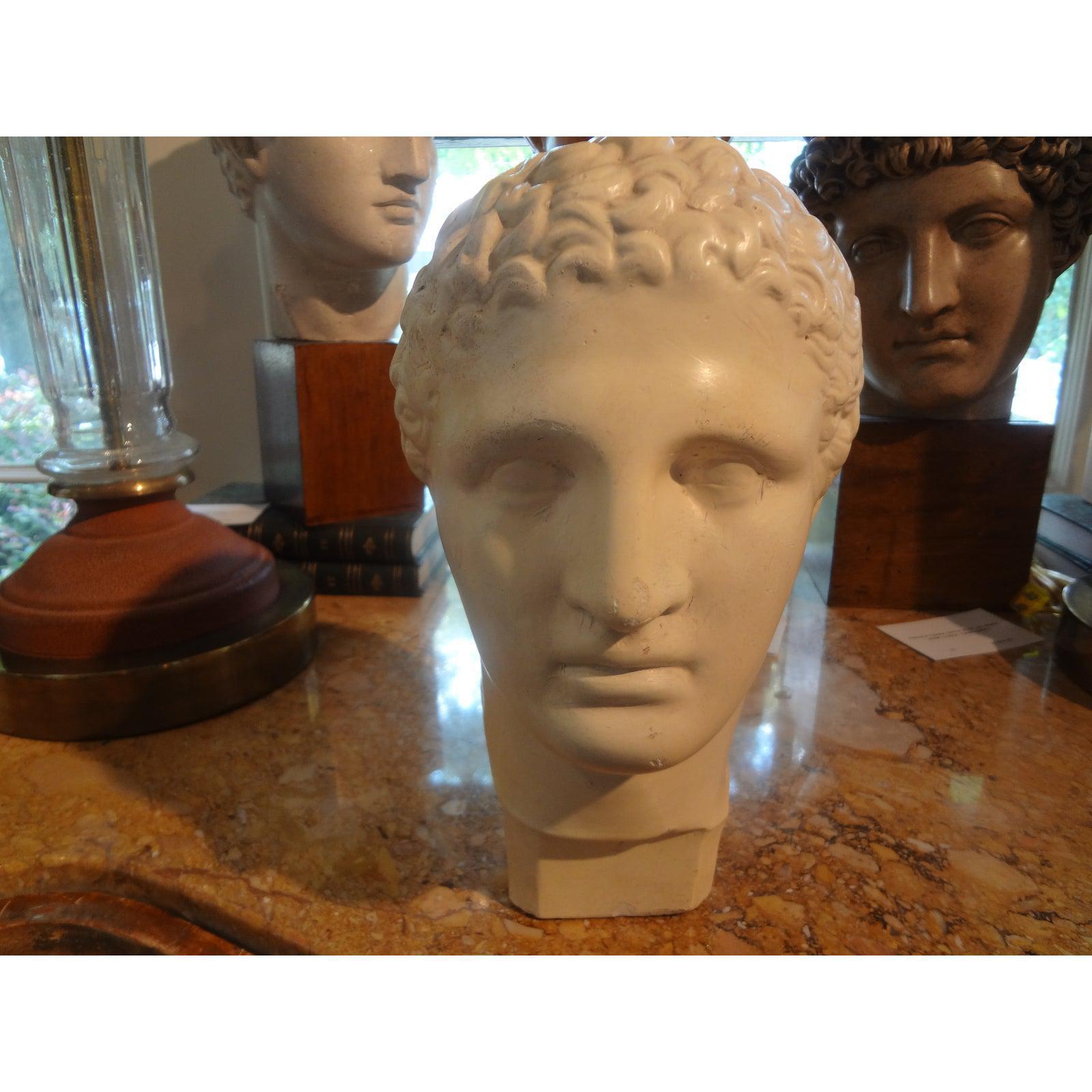 French plaster bust sculpture of a classical male from the 1920s. This gorgeous antique bust would look great on a pedestal, console table or in a bookcase.