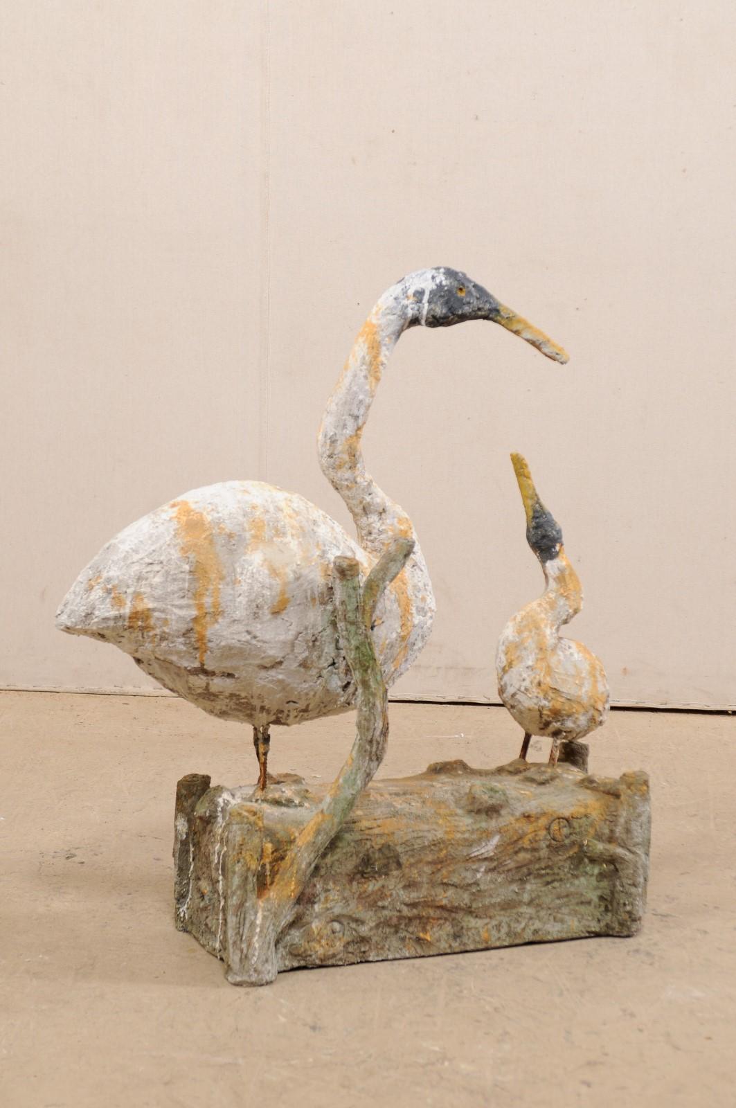 A French artisan created goose statue with her gooseling standing on faux bois log. Measure: 3+ ft tall. This vintage statue from France was created from plaster, in the image of a mother goose and her gooseling, and was mounted onto an older faux