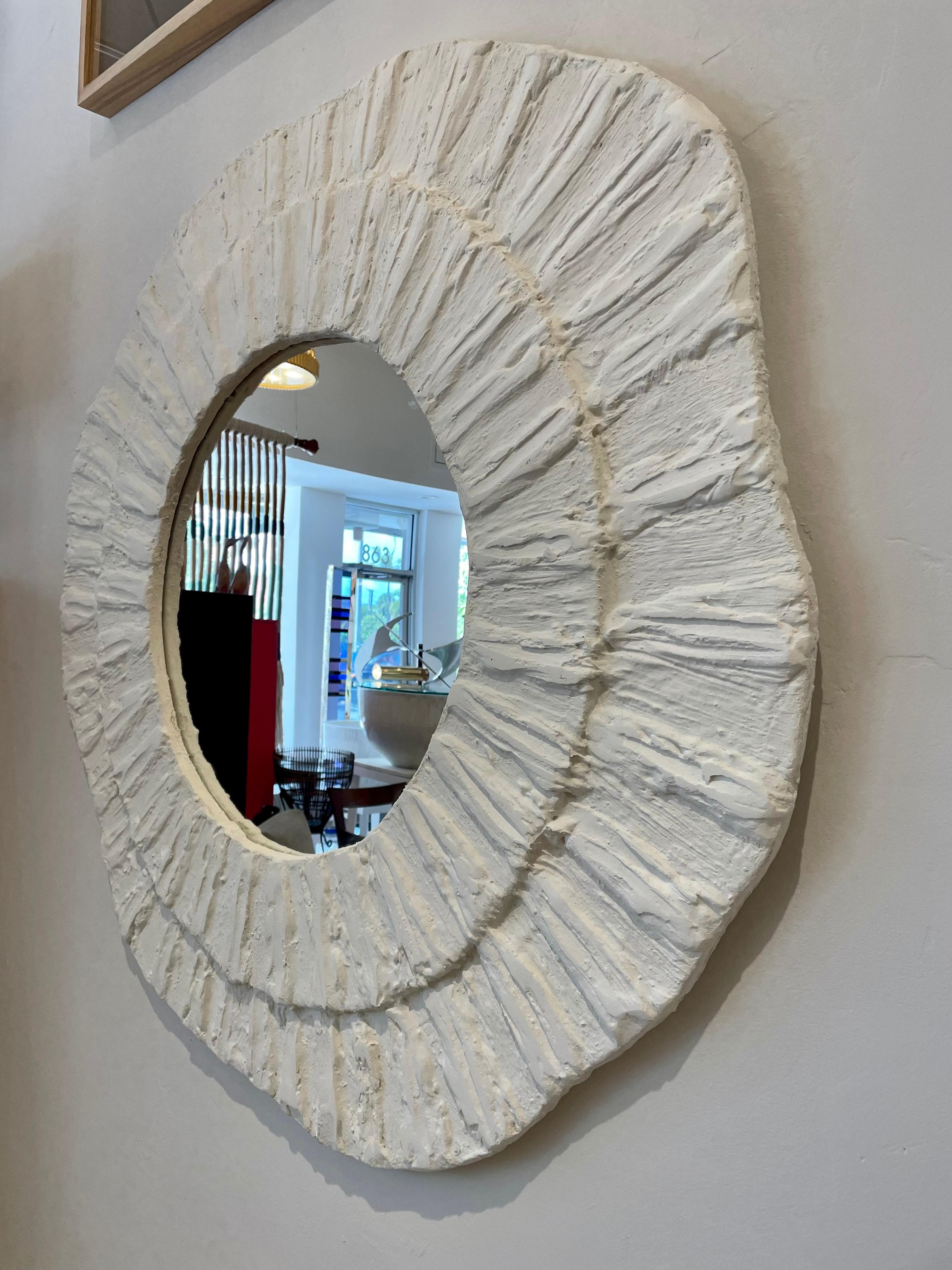This wonderful textured French plaster mirror in a wavy designed frame in two spheres. Very organic and modern - tres chic! Measure: 4 feet diameter.

Note: we have two available but sold separately.