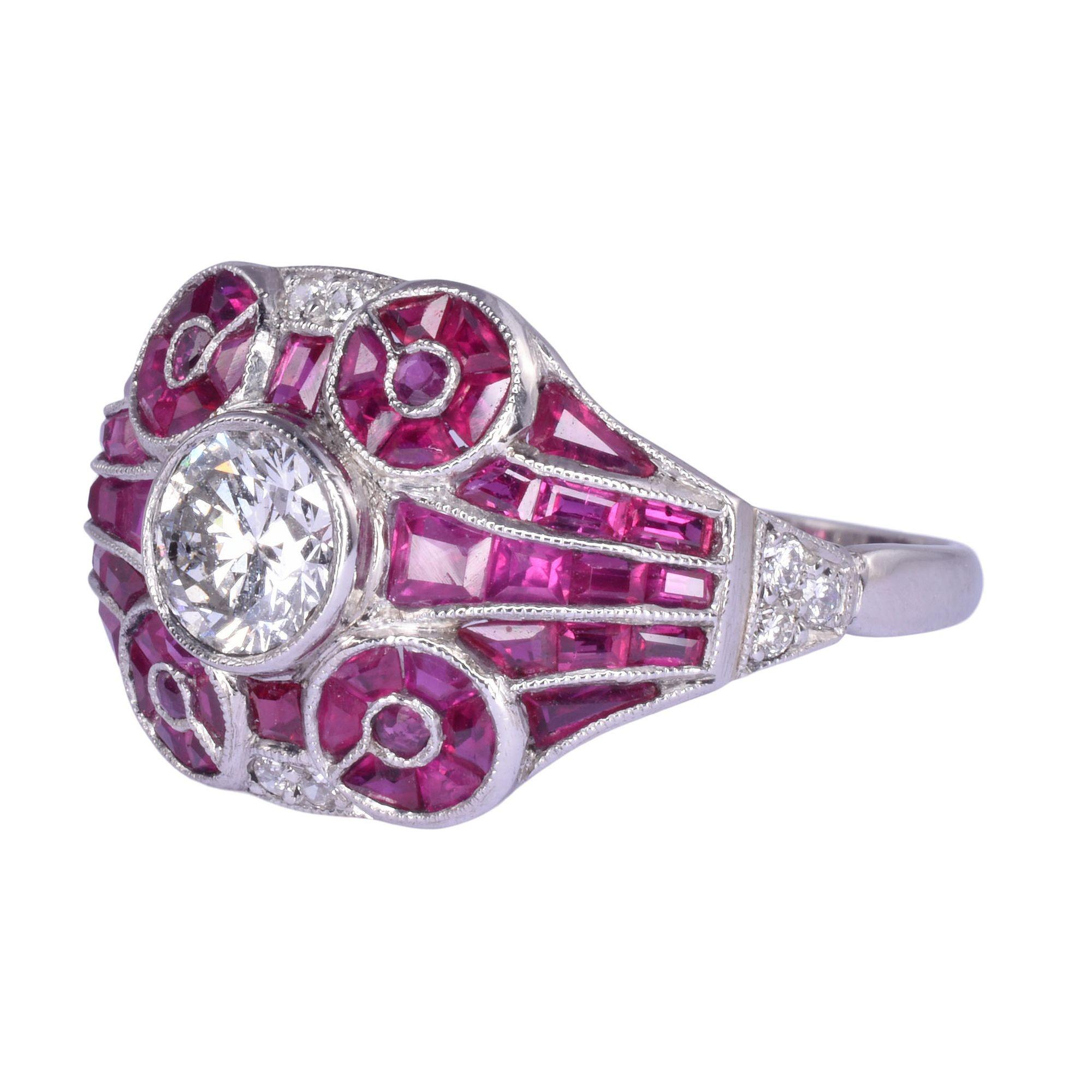 Vintage French platinum diamond ruby ring, circa 1940. This vintage French ring is handmade in platinum featuring a .50 carat round brilliant cut center diamond with SI2 clarity and K color. It is accented with 54 rubies at 1.30 carat total weight.