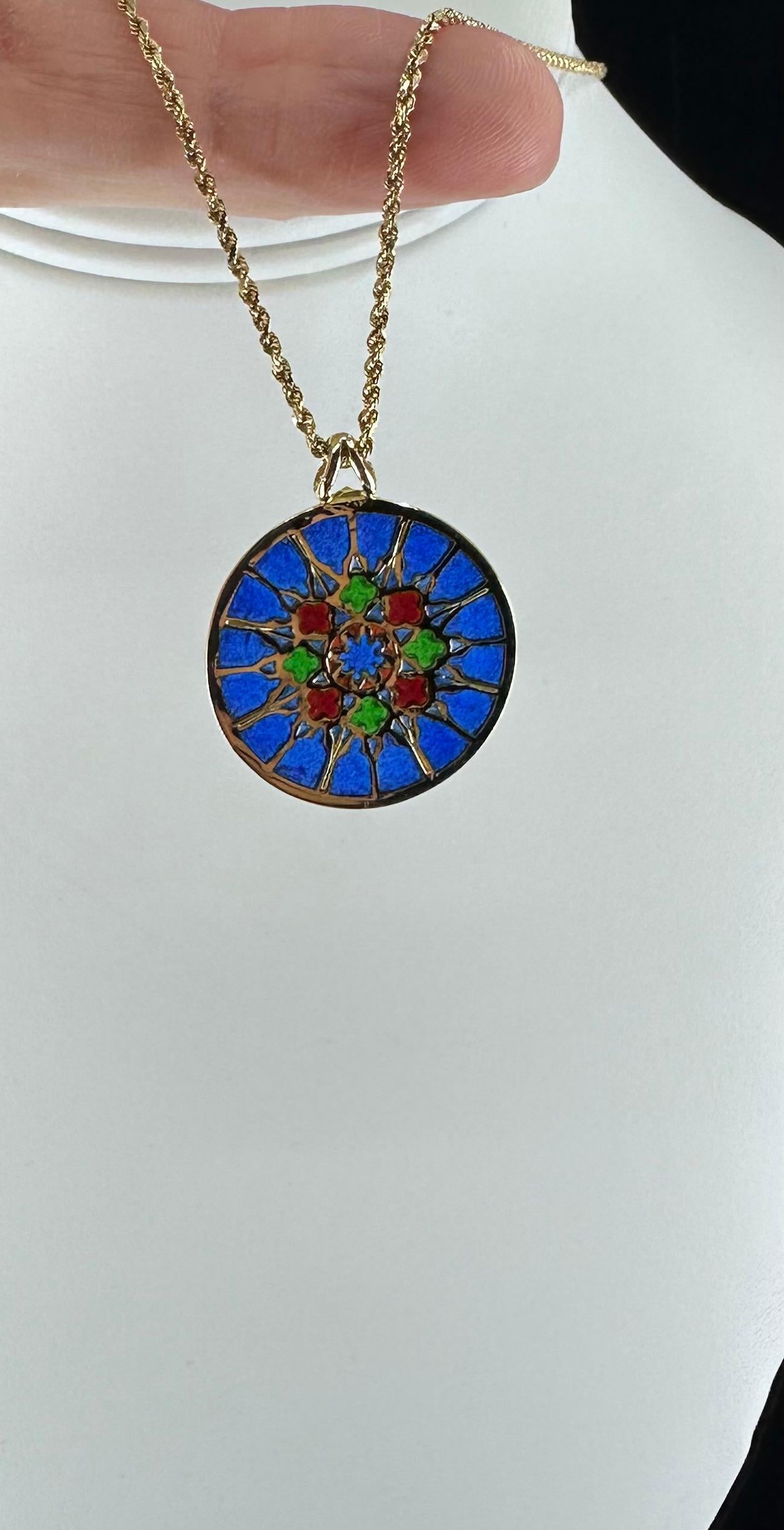 French Enamel Medallion Hallmarked with French Eagles Head, Workshop Stamp and 750 on 14k Rope Chain 20 inch.
Recalling the Stained Glass Windows of the Notre Dame Cathedral in Paris. The Plique A Jour Enamels displays a vibrant Blue, Green and Red