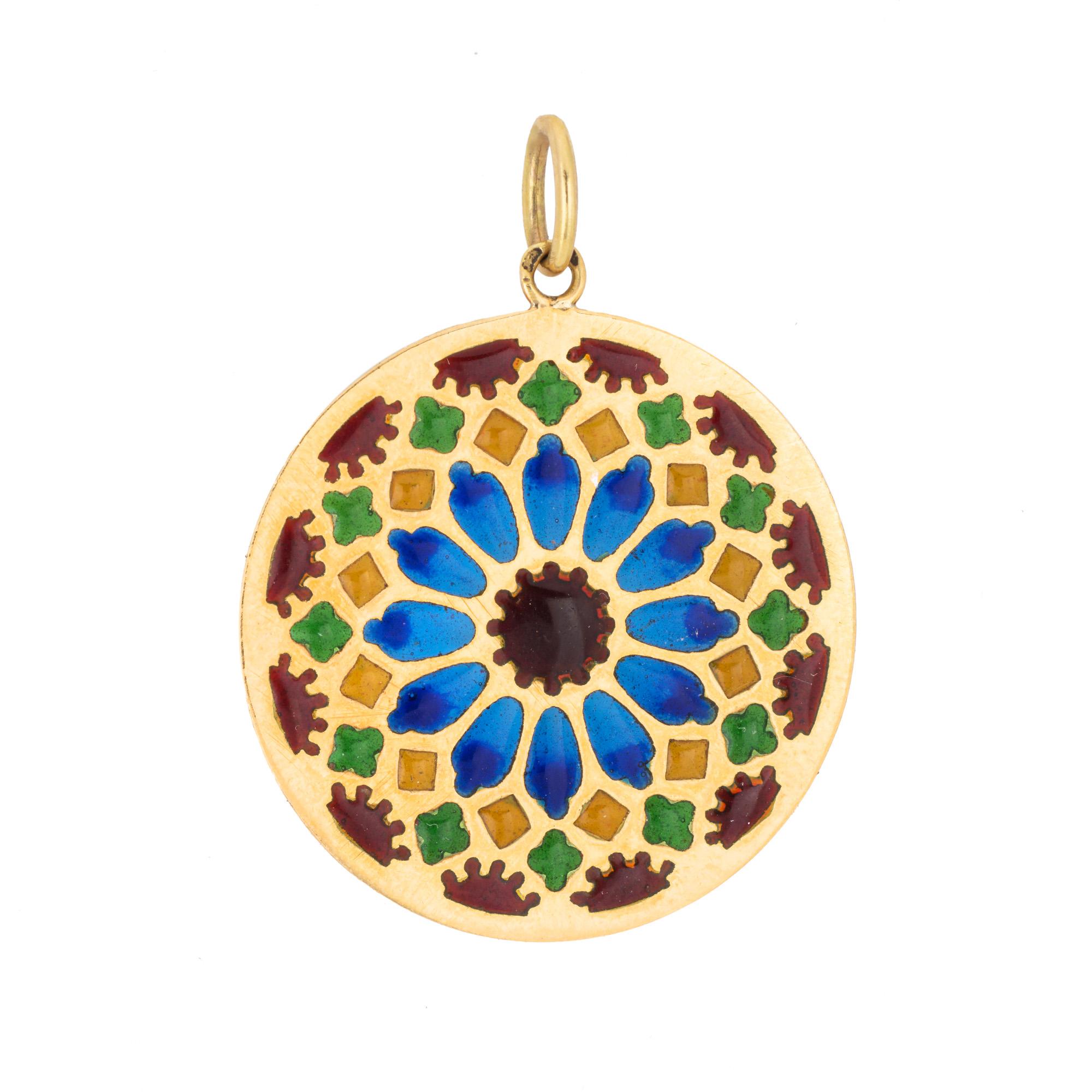 Finely detailed French plique a jour pendant (circa 1920s to 1930s), crafted in 18 karat yellow gold.

A kaleidoscope of colors adorn the pendant in shades of red, blue, yellow and green.
 
Plique a jour is a French term for 'letting in daylight'.