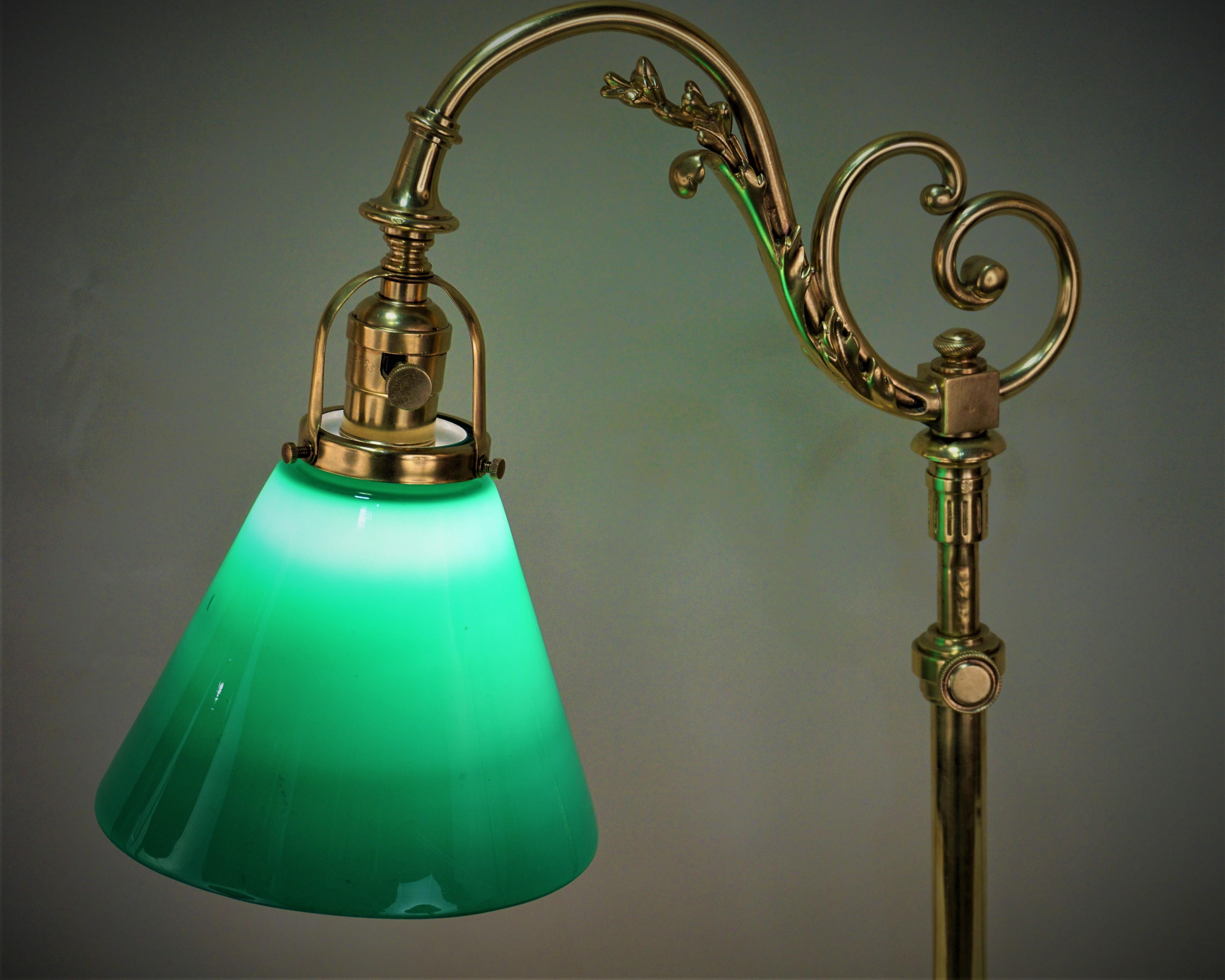 Hand polished bronze adjustable height table or desk lamp with case glass green and white shade.