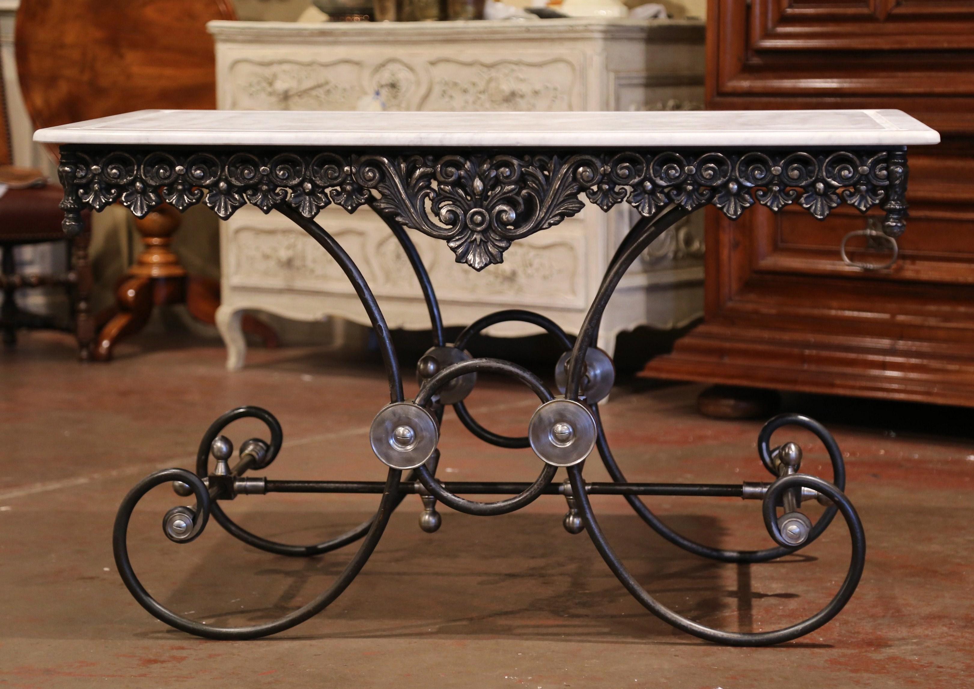 This large butcher table, or pastry table, would add the ideal amount of surface space to any kitchen. Crafted in France, this table stands on four scrolled legs over an intricate stretcher and decorative mounts and finials. The table has a