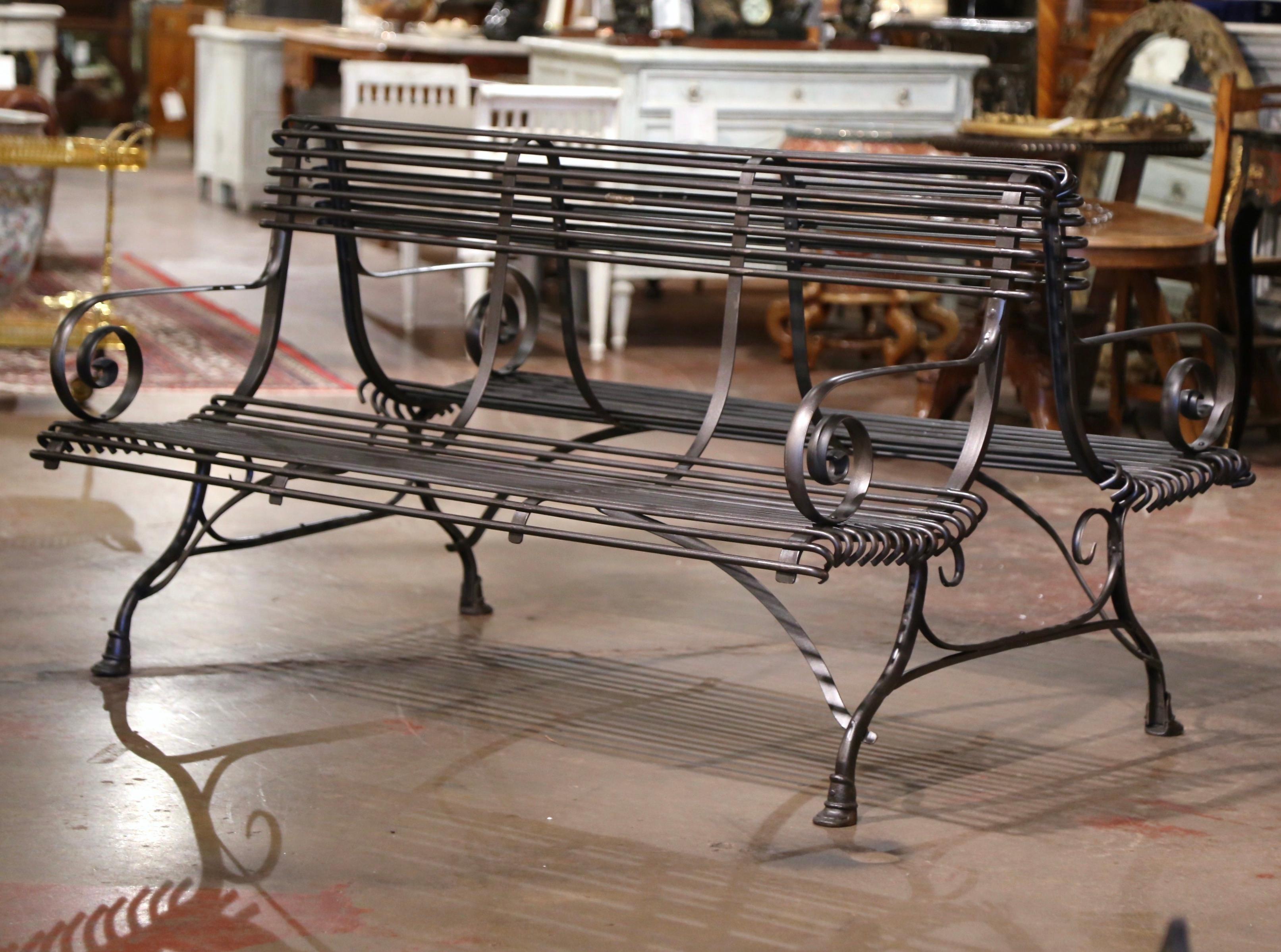 Add extra seating to a covered outdoor space with this elegant yet simple forged iron double bench from France. Complete with a gun barrel finish, the six-seat bench has gracious lines, beautifully scrolled armrests, a curved back and four legs
