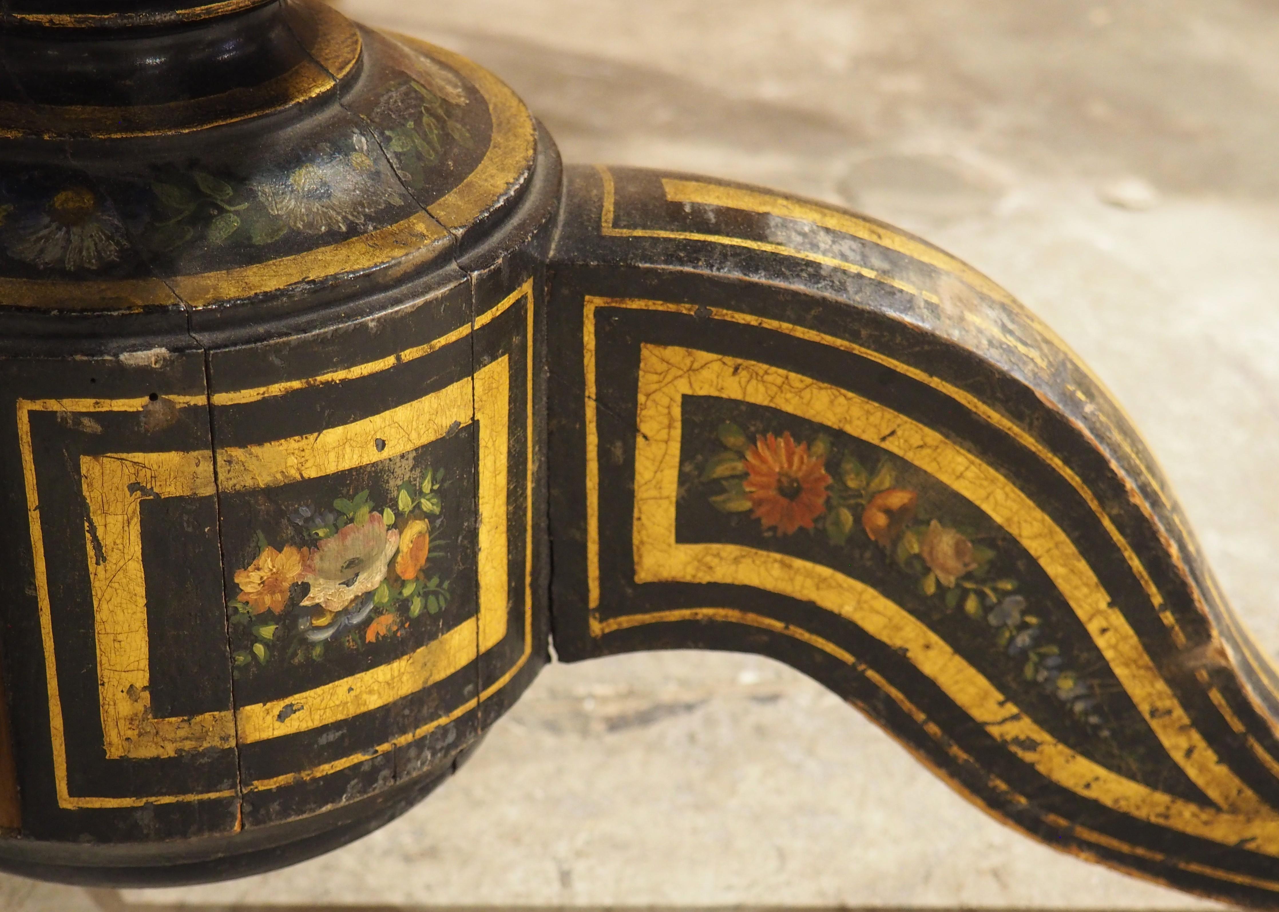 More information coming soon…

A beautiful pedestal table from the 1800s, this French table has a polychrome hand-painted and ebonized finish.  The top, which has a chamfered edge, has been painted with a genre scene of three children beneath the