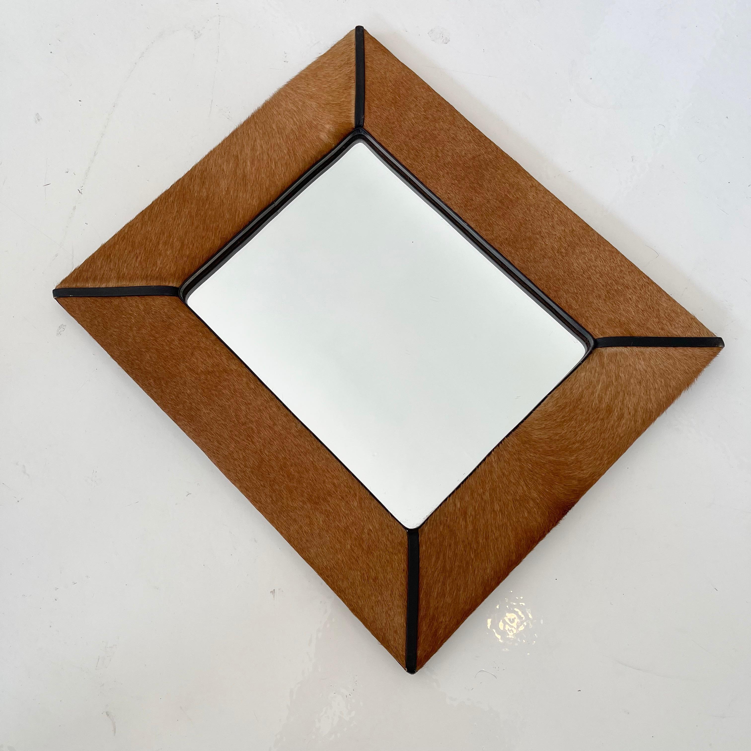 Handsome mirror made in France, circa 1960s. Pony hair with leather trim. Good vintage condition. Great design.