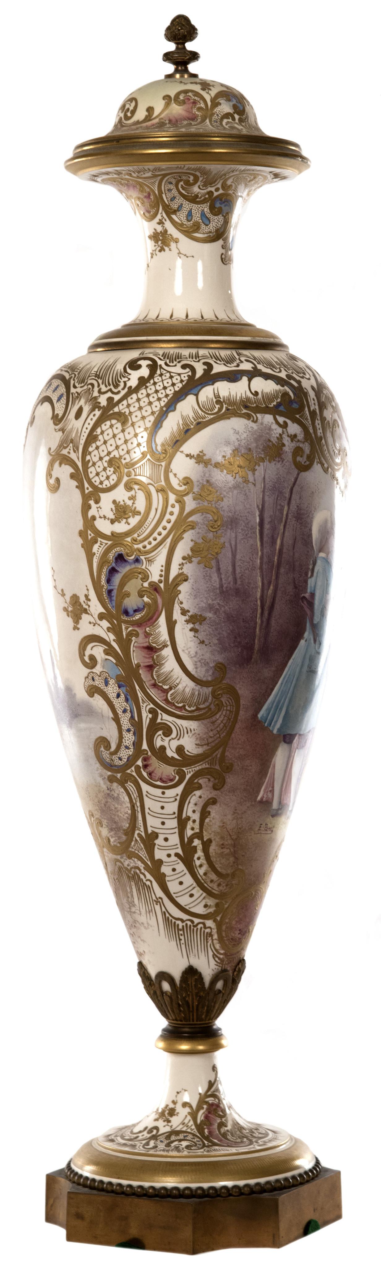 A 19th century French porcelain vase of slim baluster form with slender neck that is decorated with gilded bands and detailed foliate designs, surmounted by a pinecone-shaped finial capping the lid, the tapering and gilt trimmed foot mounted to a