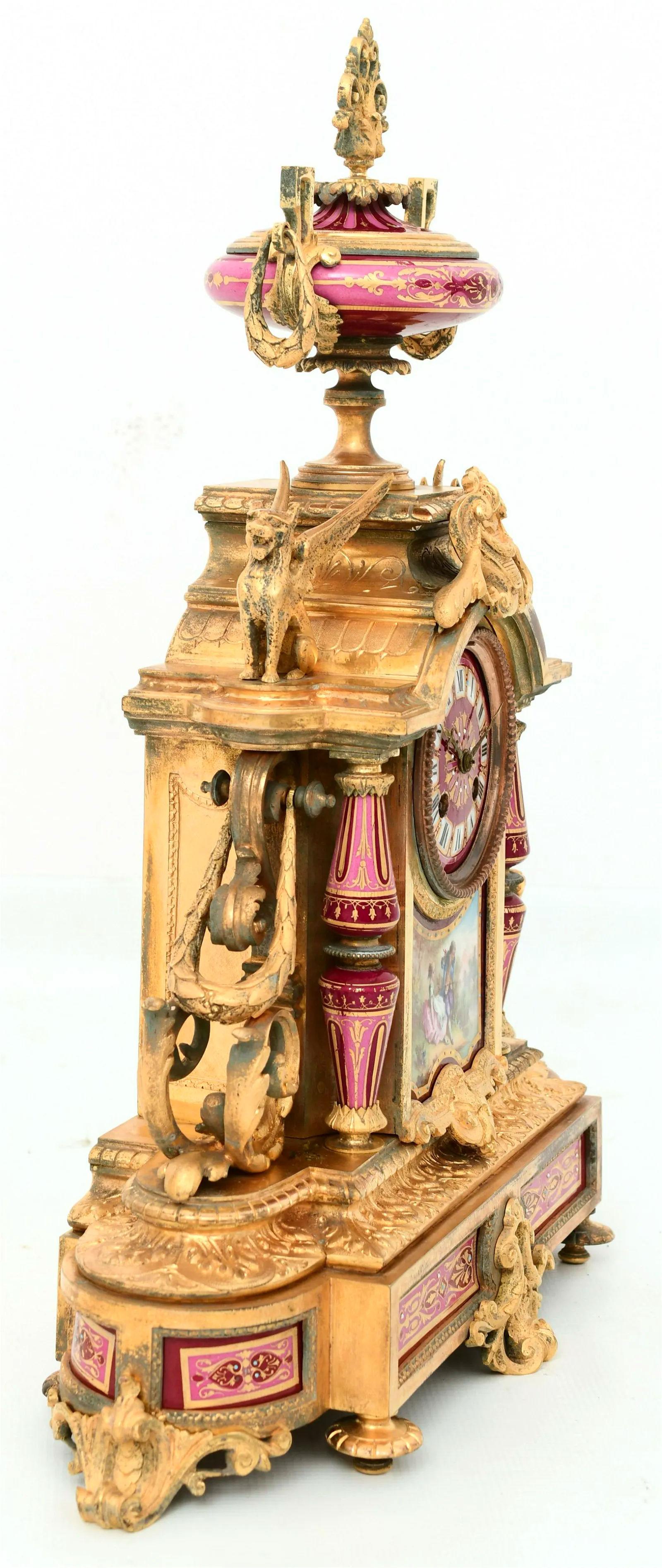 Very fine quality 19 century French Porcelain and Gilt Bronze Mantel Clock Garniture with hand painted Sevres style porcelain plaques.
Mantel clock 20 1/2 by 17 by 6 inches. Urns 15 1/2 by 7 by 5 inches. Movement by Japy Freres.