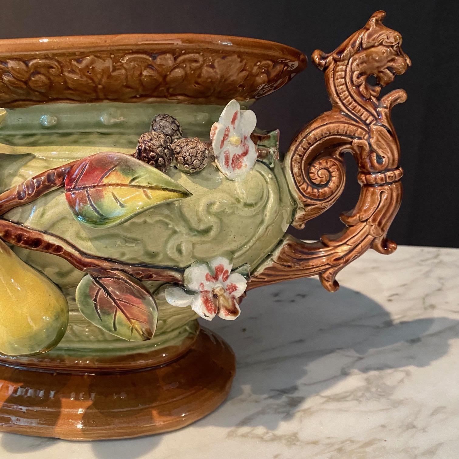 Really lovely French soup tureen or jardiniere, bought in the south of France. Aesthetic movement, with robust fruit depicted in sculpted pears on vines with blooming flowers. Handles are wide eyed tigers, and on the other side is a bearded