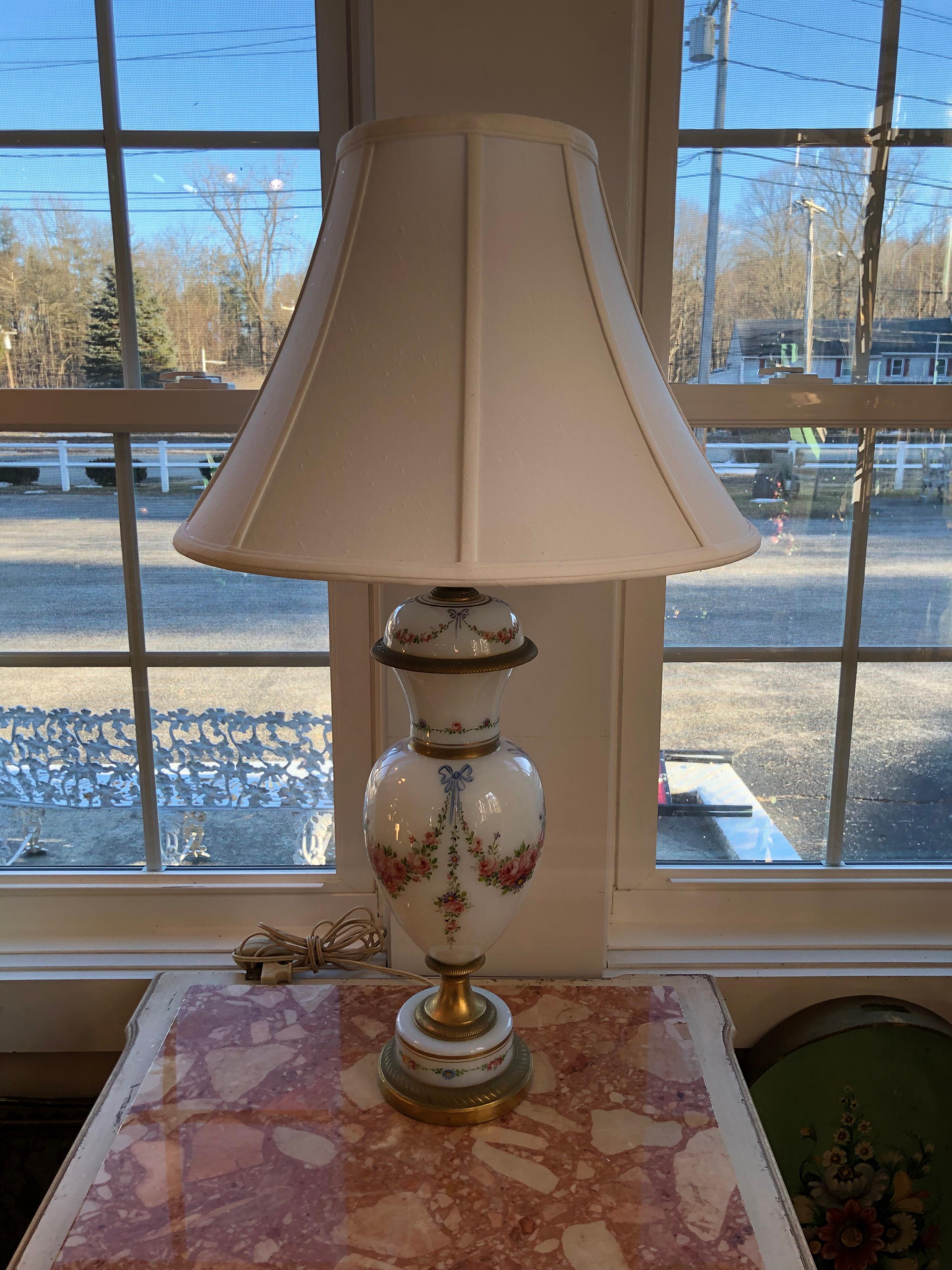 French porcelain hand signed lamp. Heavy and weighted. Brass base. A beautiful addition to light up any room. Signed and hand painted. Singed R. Werner artist. Delicate and feminine. Perfect for a little girls room. With shade measures: 31 high and