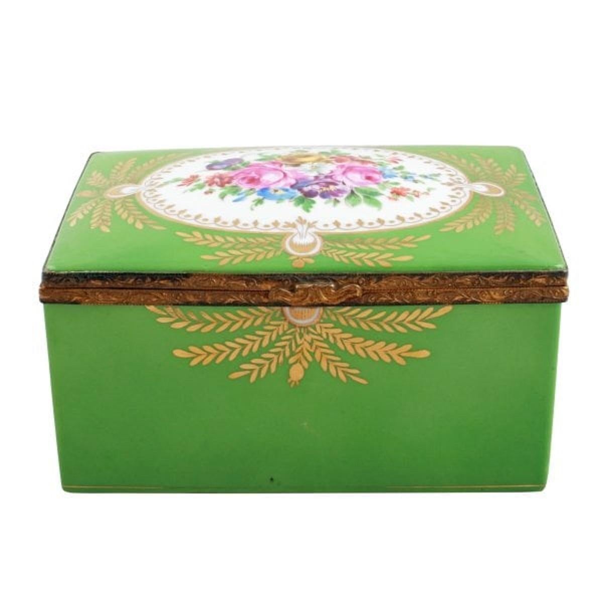 An beautiful 19th century French porcelain jewel or trinket box.

The box has a domed hinged lid that is decorated with hand painted flowers and gilt detail.

The lid and box edges are gilt brass and the underside of the lid has hand painted