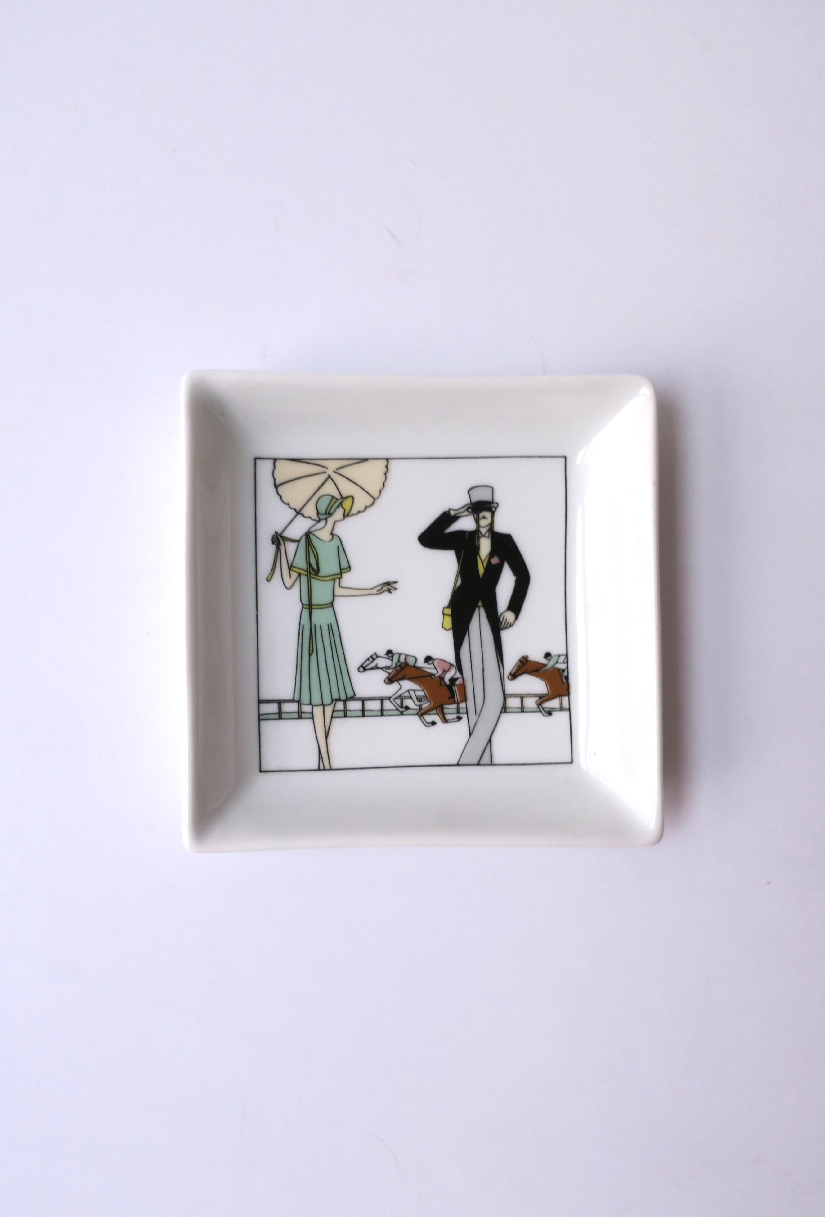 A French porcelain jewelry dish with derby horse racing scene, circa late-20th century, France. A derby racing scene with thoroughbreds and jockey's and a finely dressed woman and man. A great dish to hold jewelry or other items on a nightstand