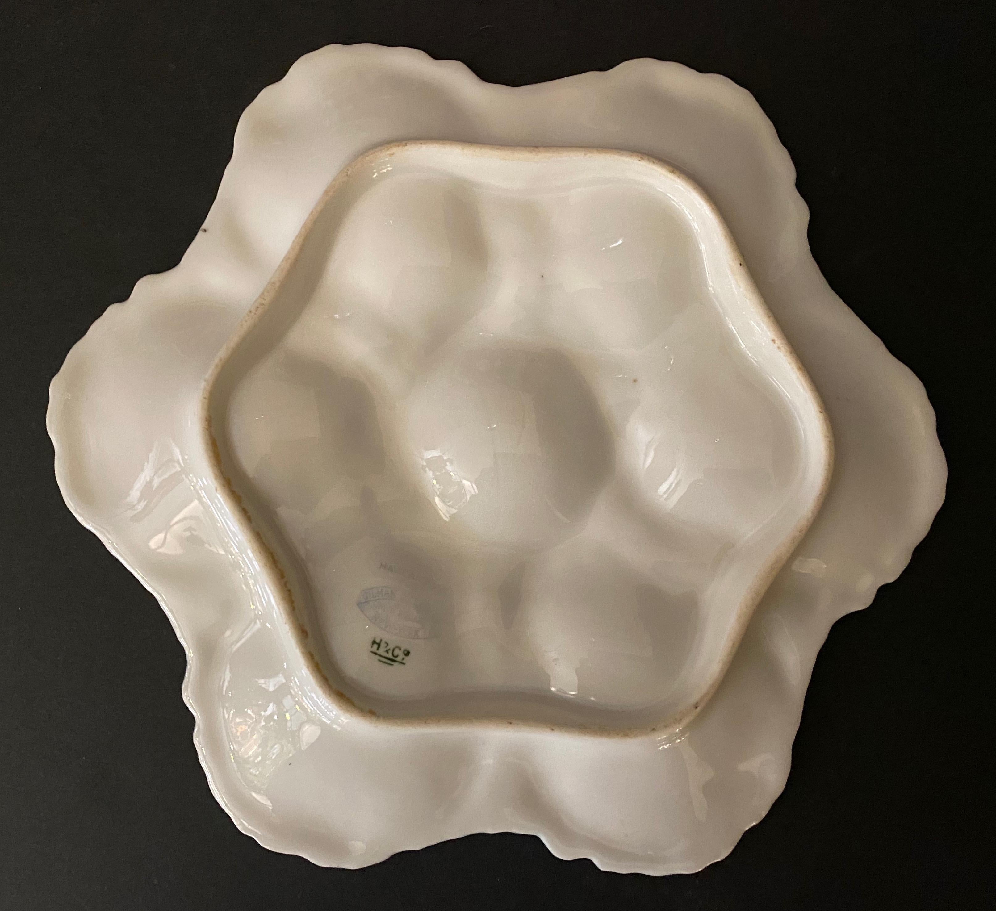 Mid-19th century Limoges porcelain oyster plate

This colorful porcelain oyster plate has 6 cases. The hand painted oyster shells are made with a very detailed relief.
The inside of the oyster shells is decorated in chromolithography with fruits