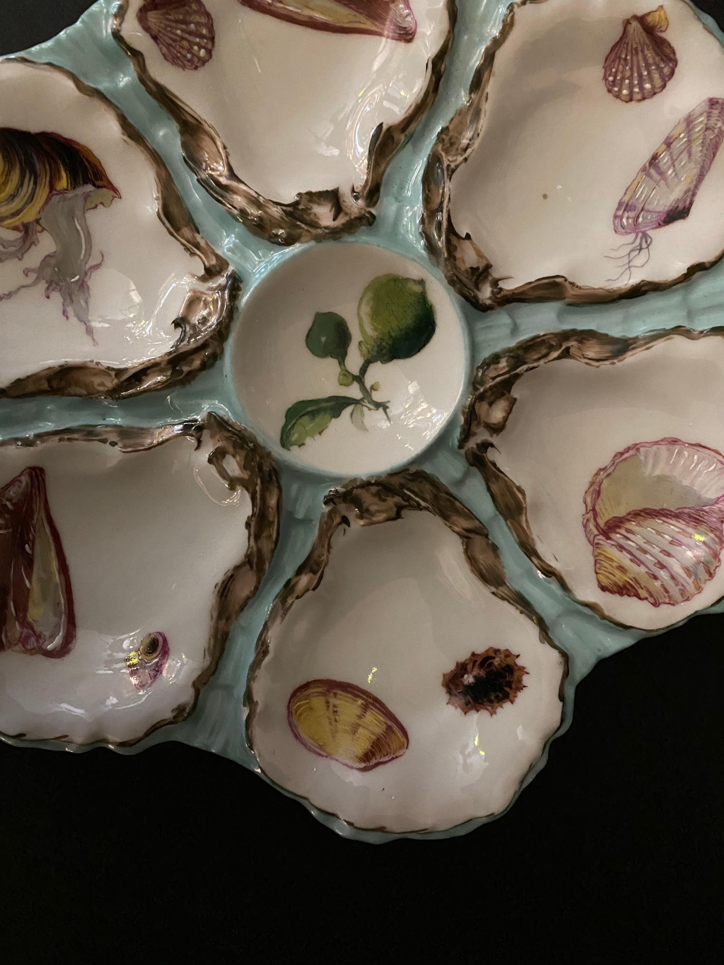 Collector piece, mid-19th century famous Haviland Limoges porcelain oyster plate, with six oyster cradle. The relief of each oyster shells is with refined hand painted details which gives an optical illusion, while the inside of the oysters is