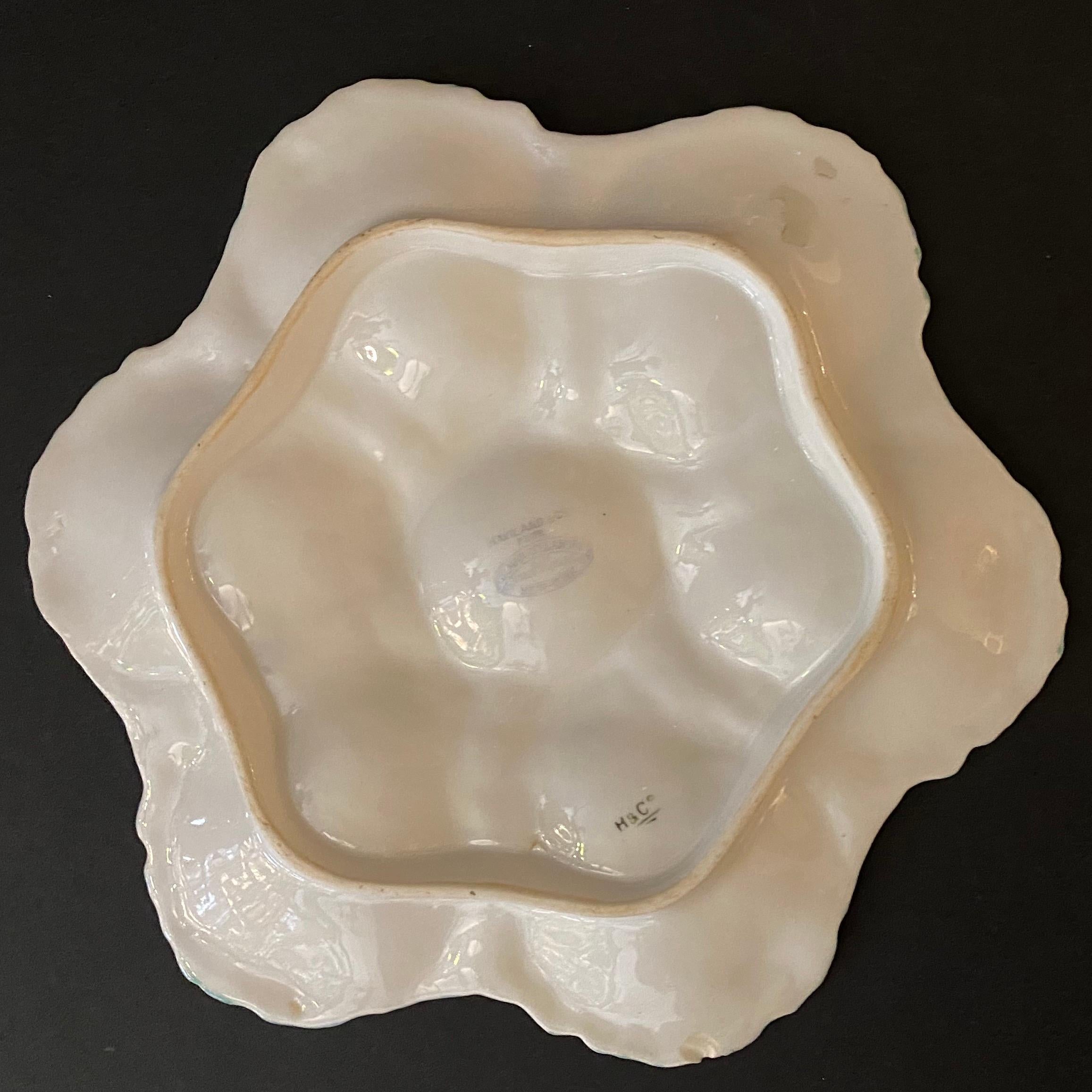 Collector piece, mid-19th century famous Haviland Limoges porcelain oyster plate, with six oyster cradle. The relief of each oyster shells is with refined hand painted details which gives an optical illusion, while the inside of the oysters is