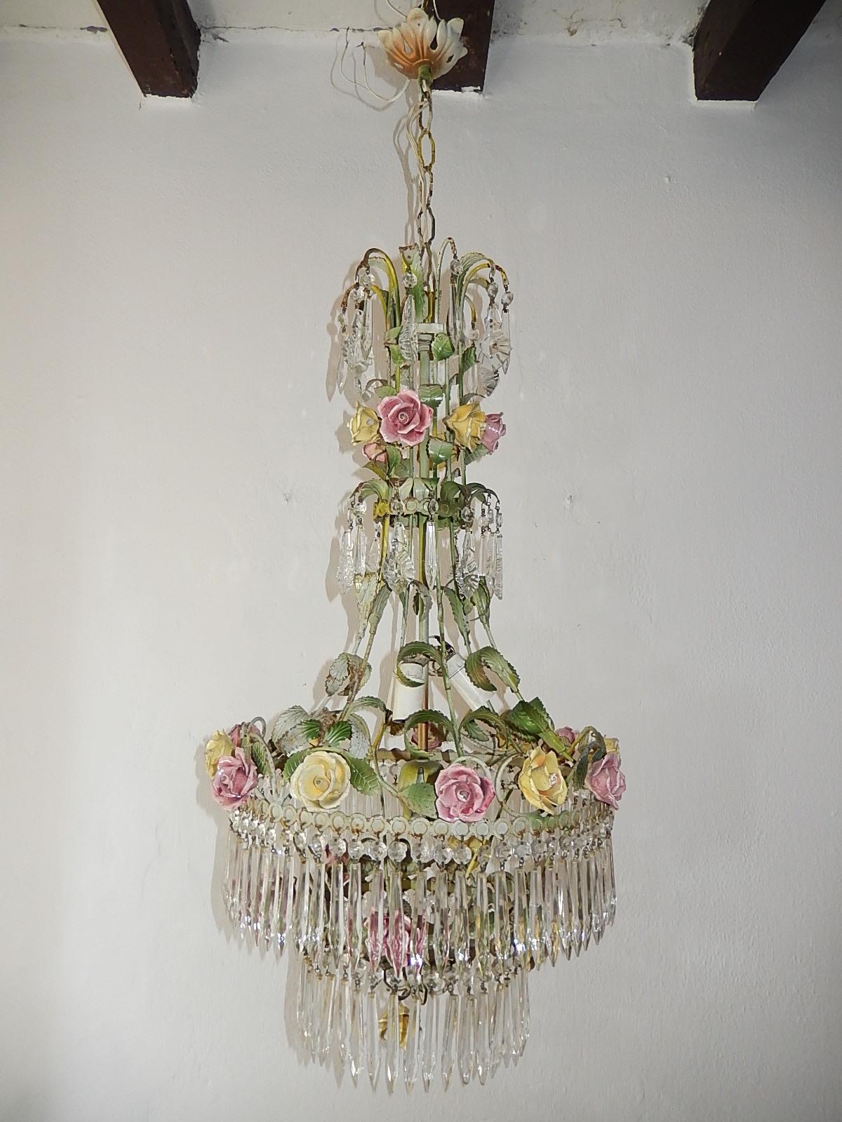 Housing four lights, will be rewired with certified UL US sockets for the USA and certified sockets for other countries and ready to hang. Green tole leaves galore. Original color tole. Four tiers of vintage crystal prisms, in spear shape. Also