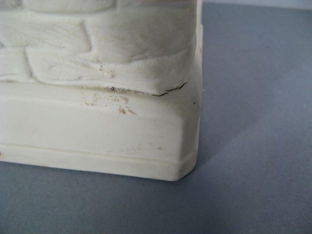 This charming piece is a French porcelain sculpture/vase depicting a child seated beside a Medici vase. Dating from the mid-20th century, it's marked 
